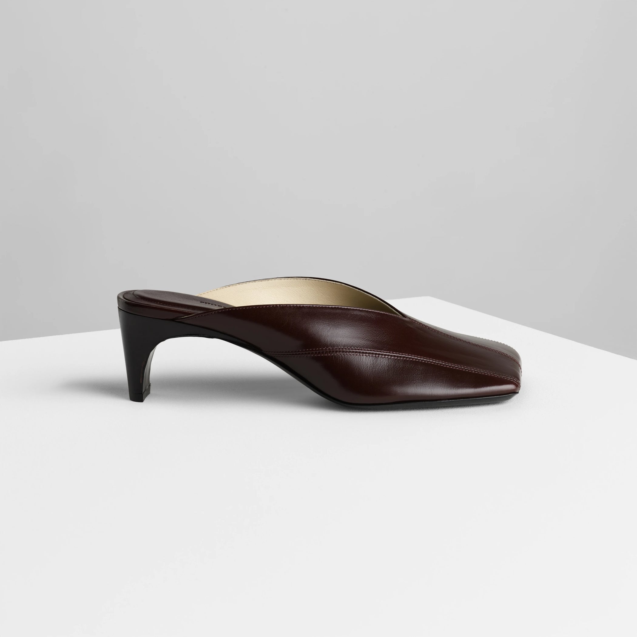 Side view of tilt mule in oxblood leather.