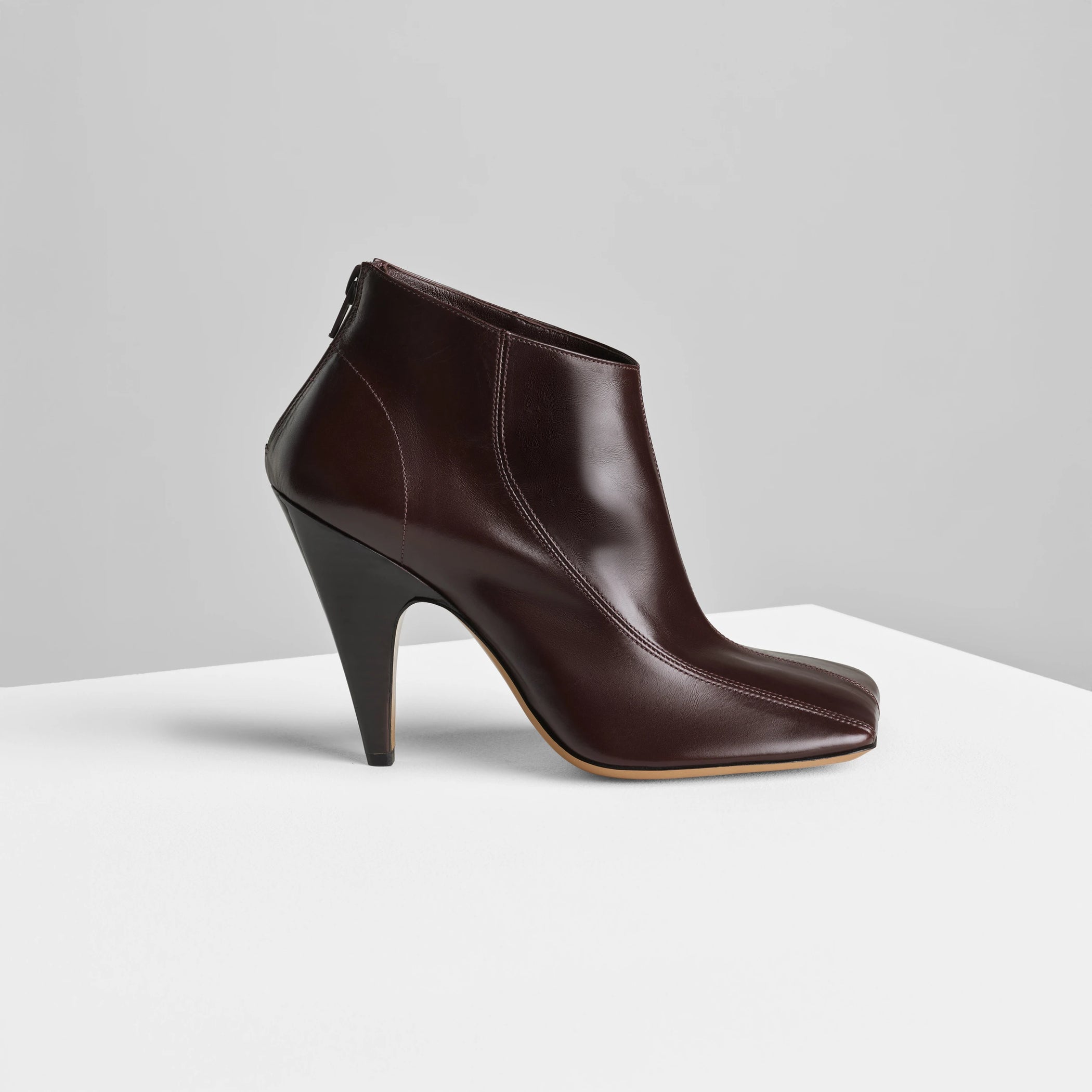 Side view of tilt ankle boot in oxblood leather.