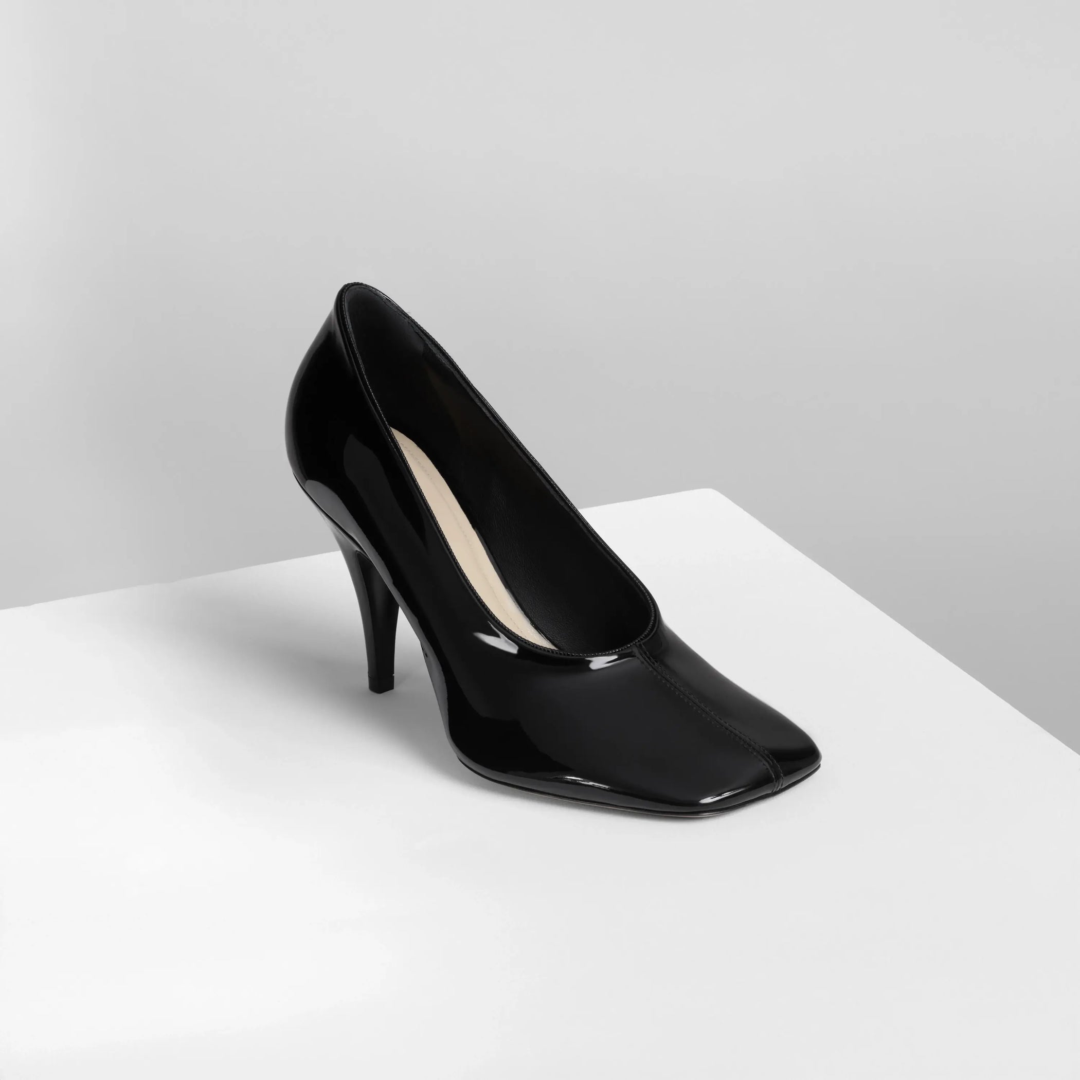 Side view of soft pump 90 in black patent leather 