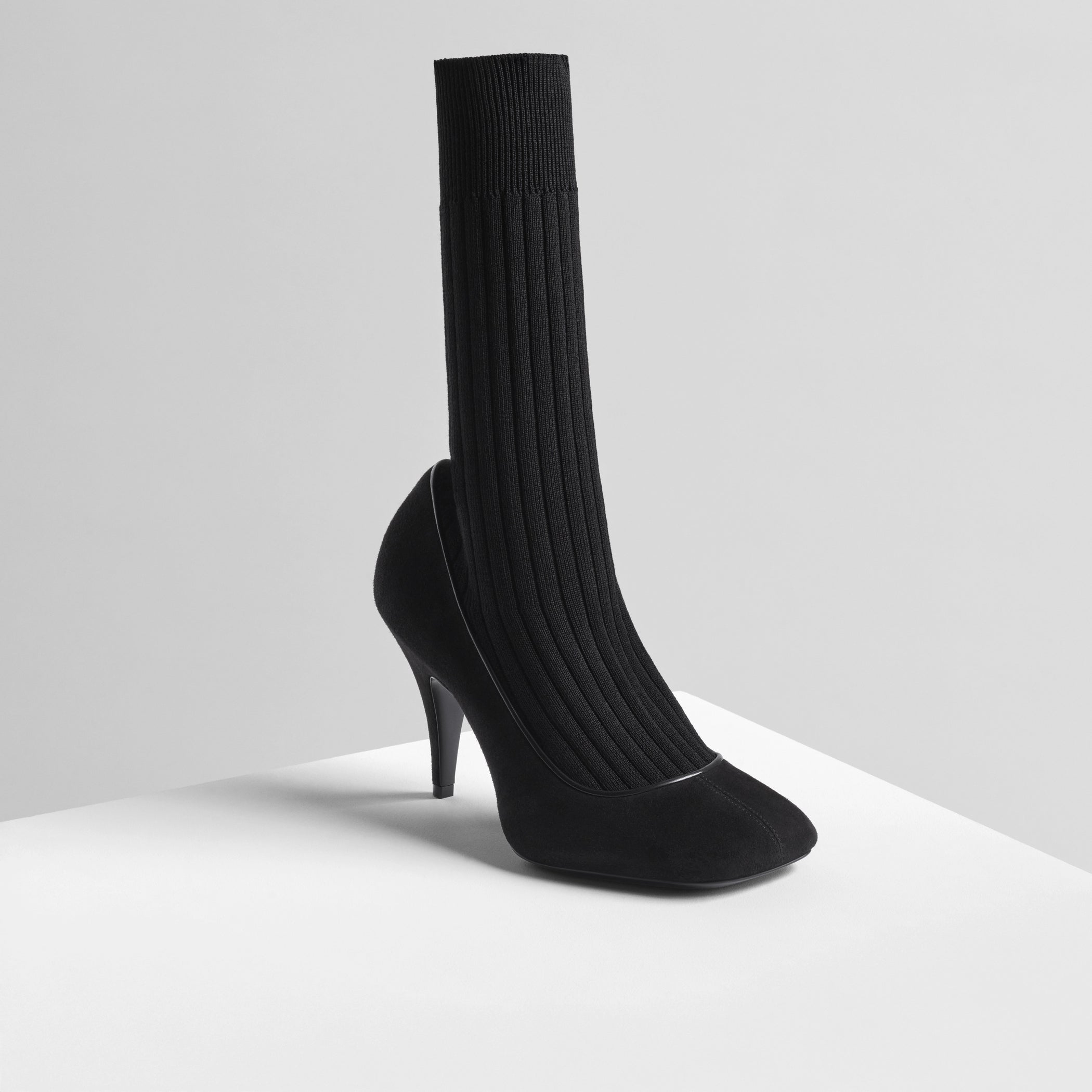 Angled front view of soft sock pump in black suede 