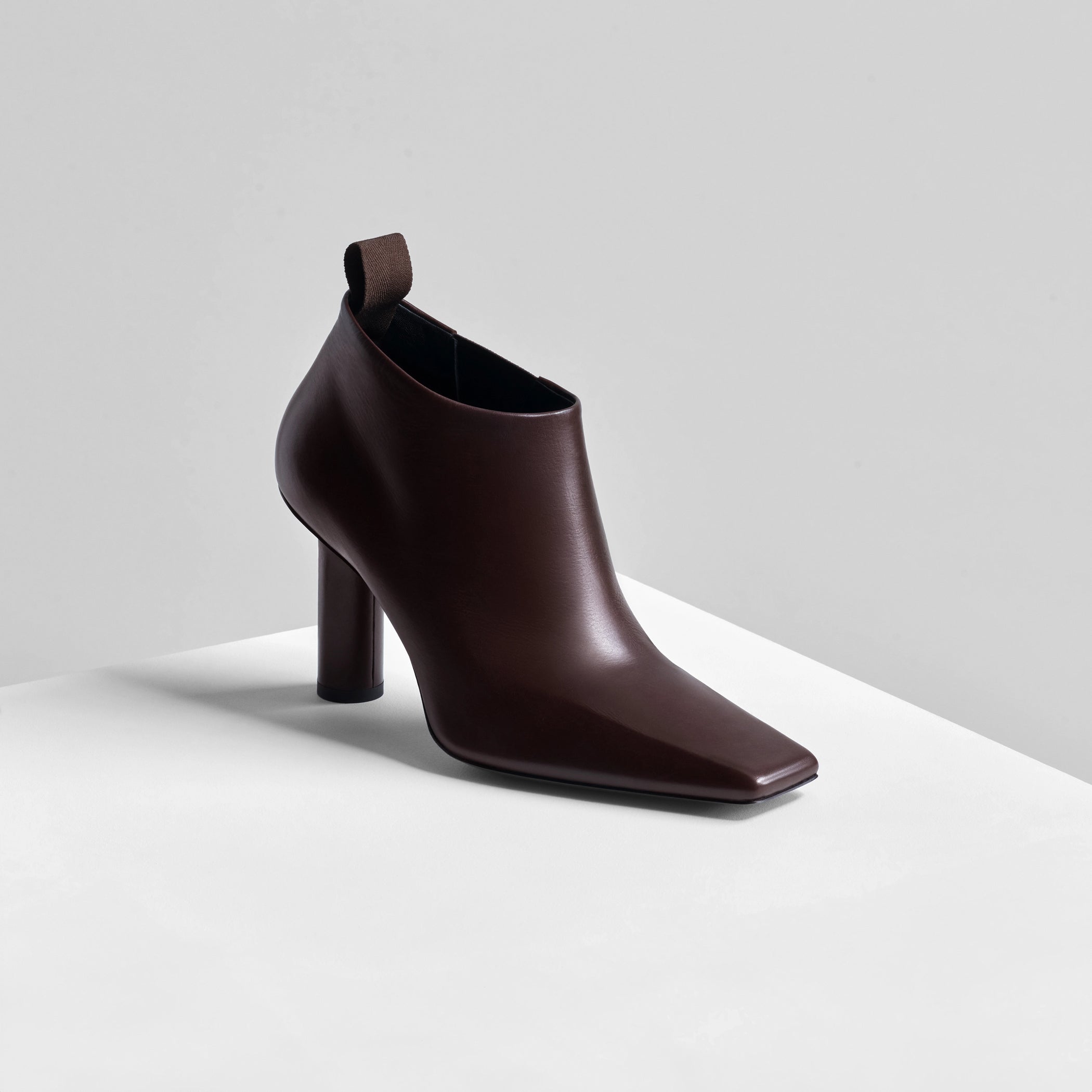 Angled front view of square edge toe boot in plum brown leather 
