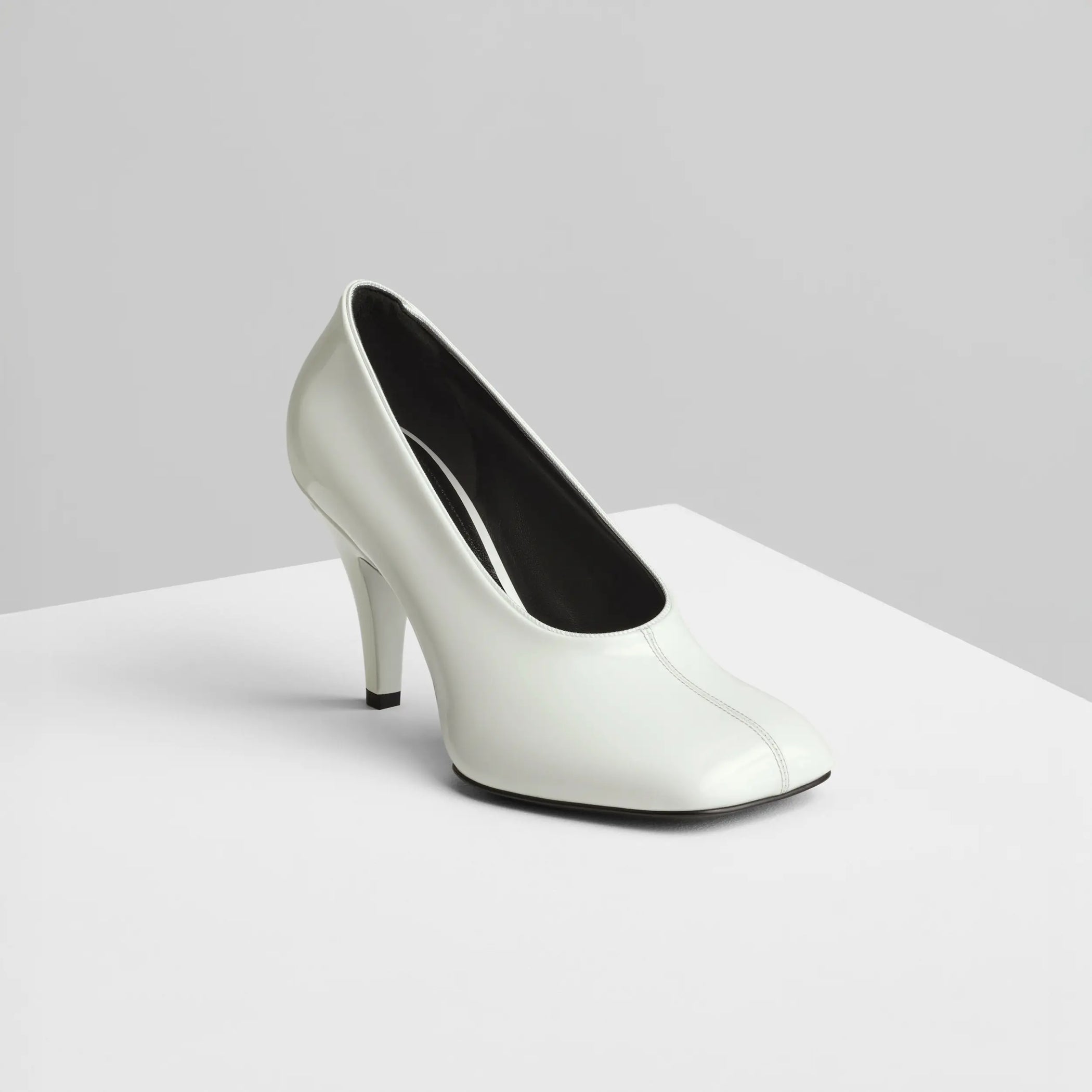 Side view of soft pump 90 in white patent leather