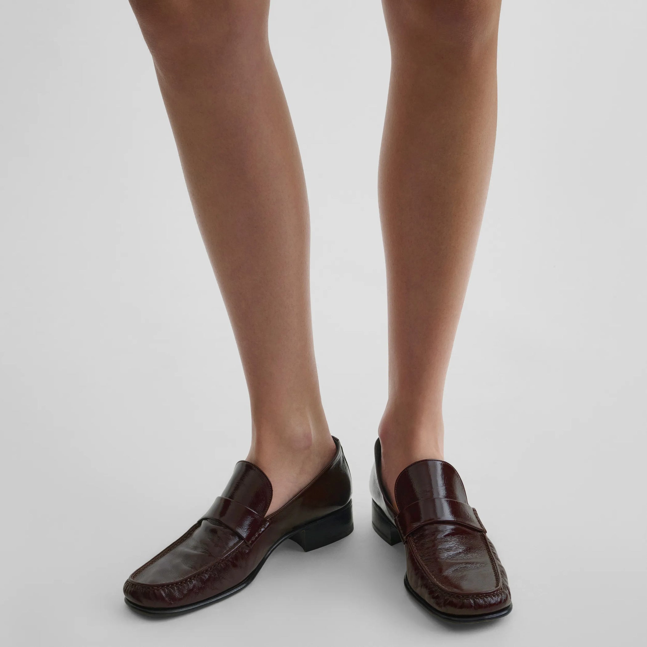 Top view of model wearing man&#39;s loafer in oxblood leather