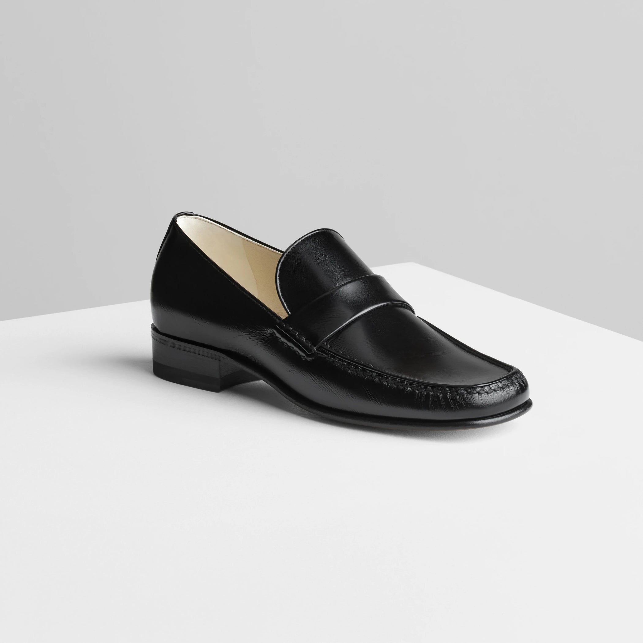 Side view of man’s loafer in black leather.
