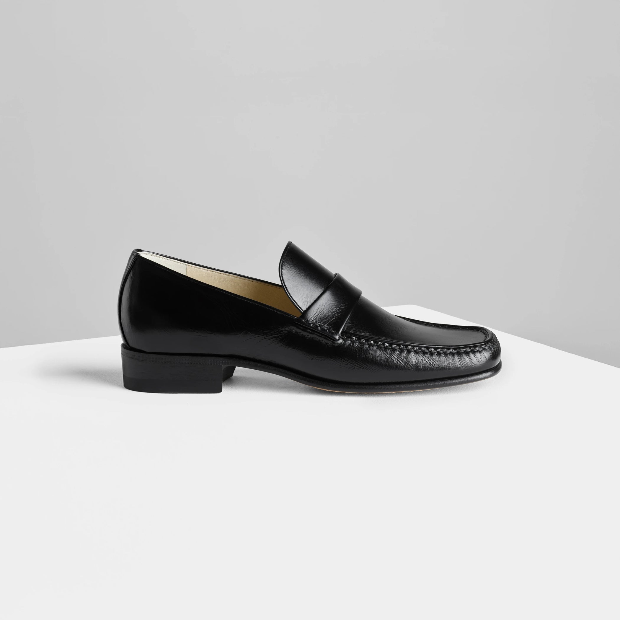 Side view of man’s loafer in black leather.