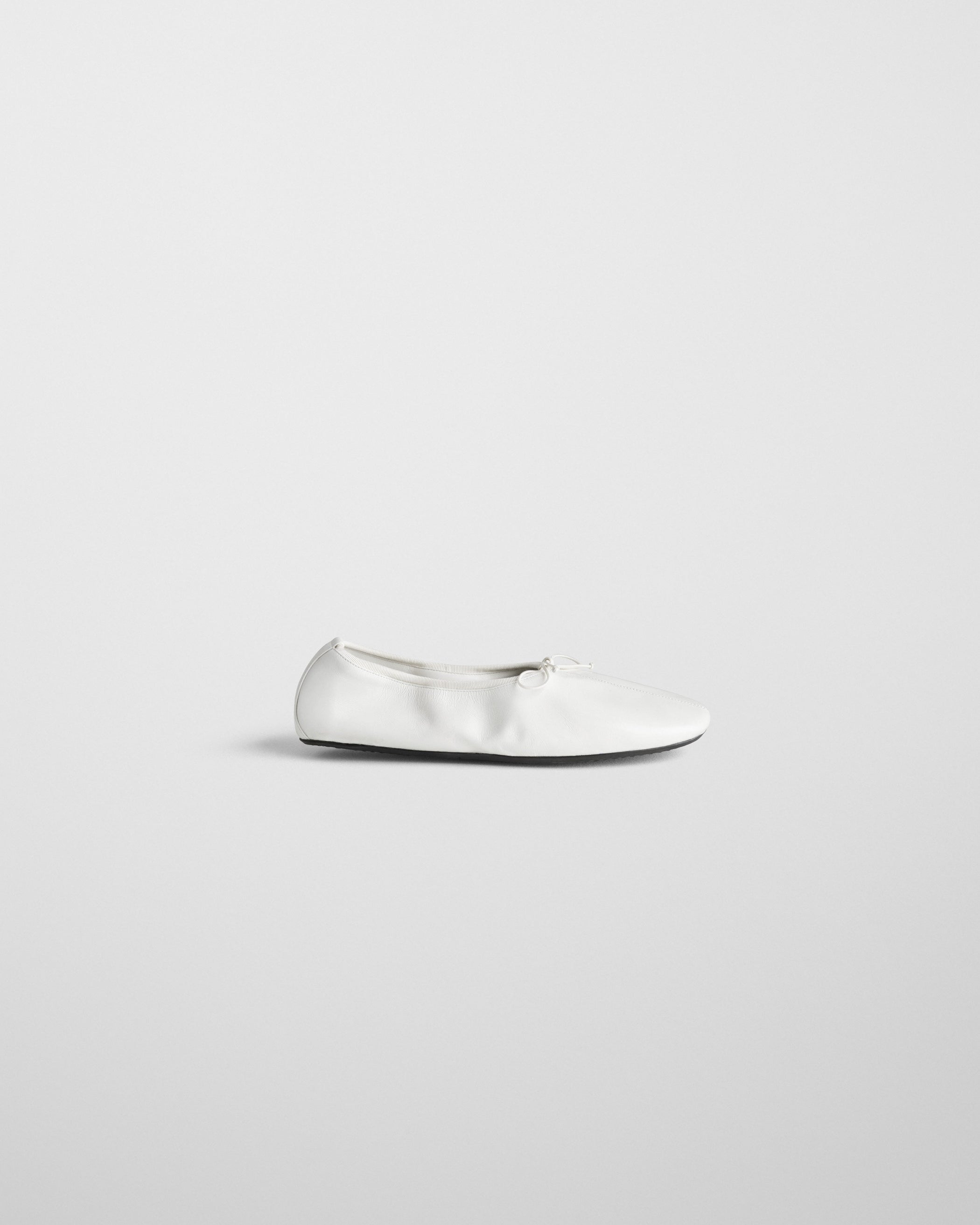 Side view of GATHERED FLAT in white leather