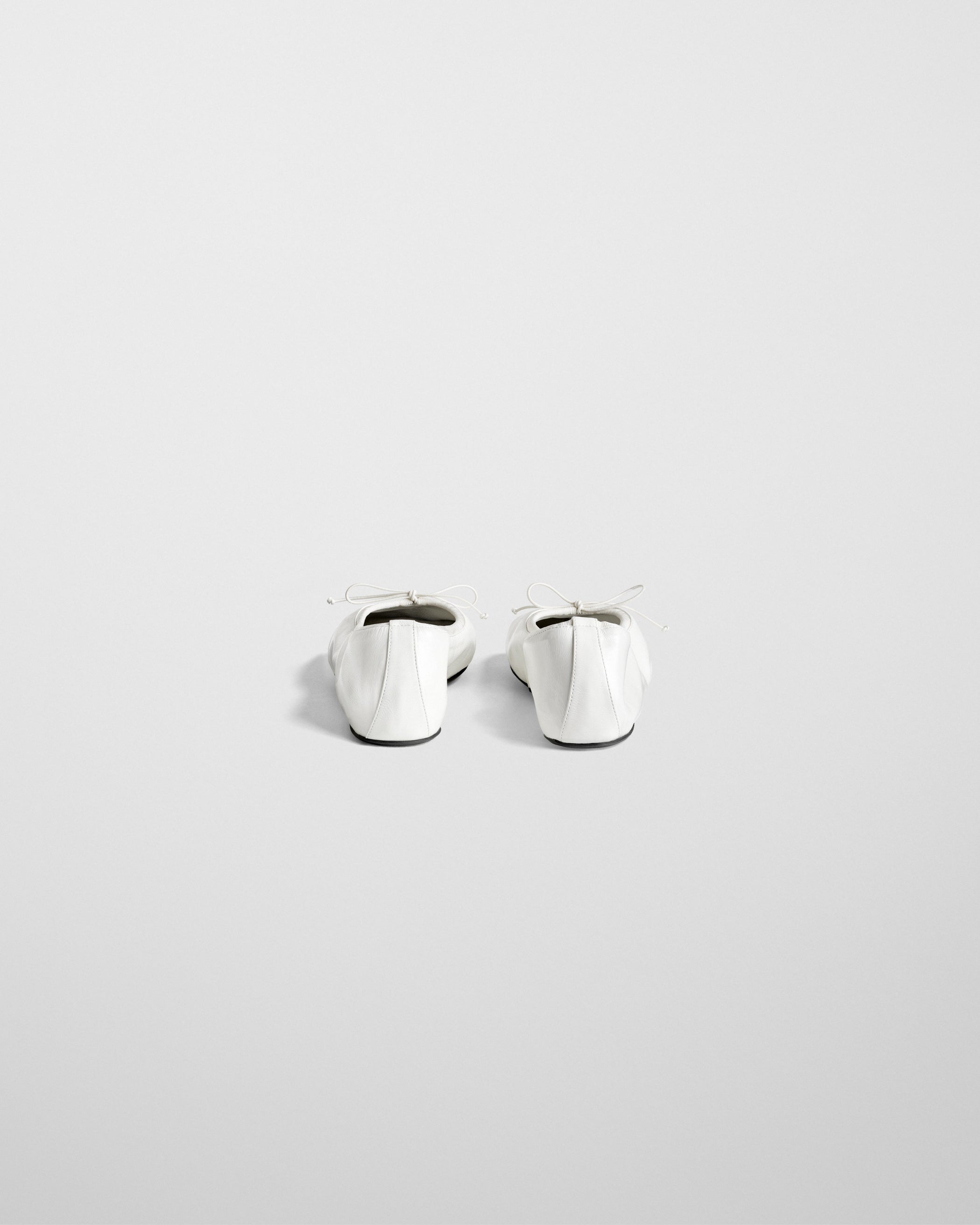 Back view of GATHERED FLAT in white leather