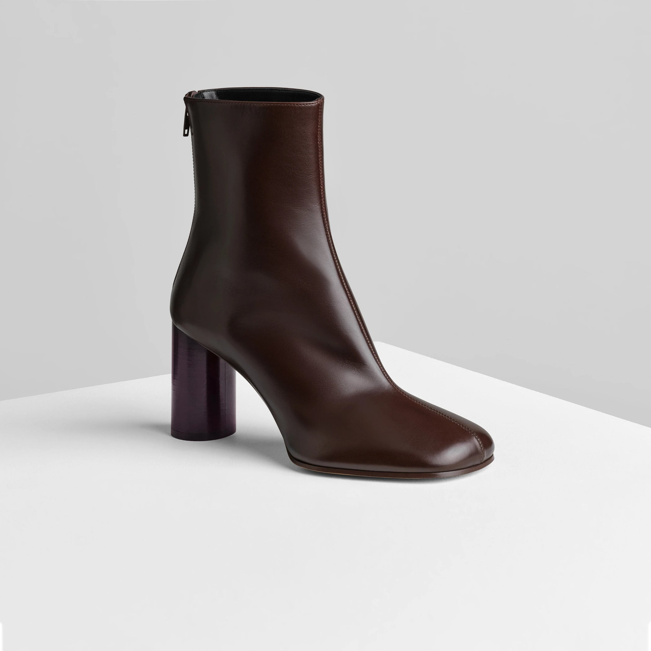 Side view of tug ankle boot in plum brown leather.