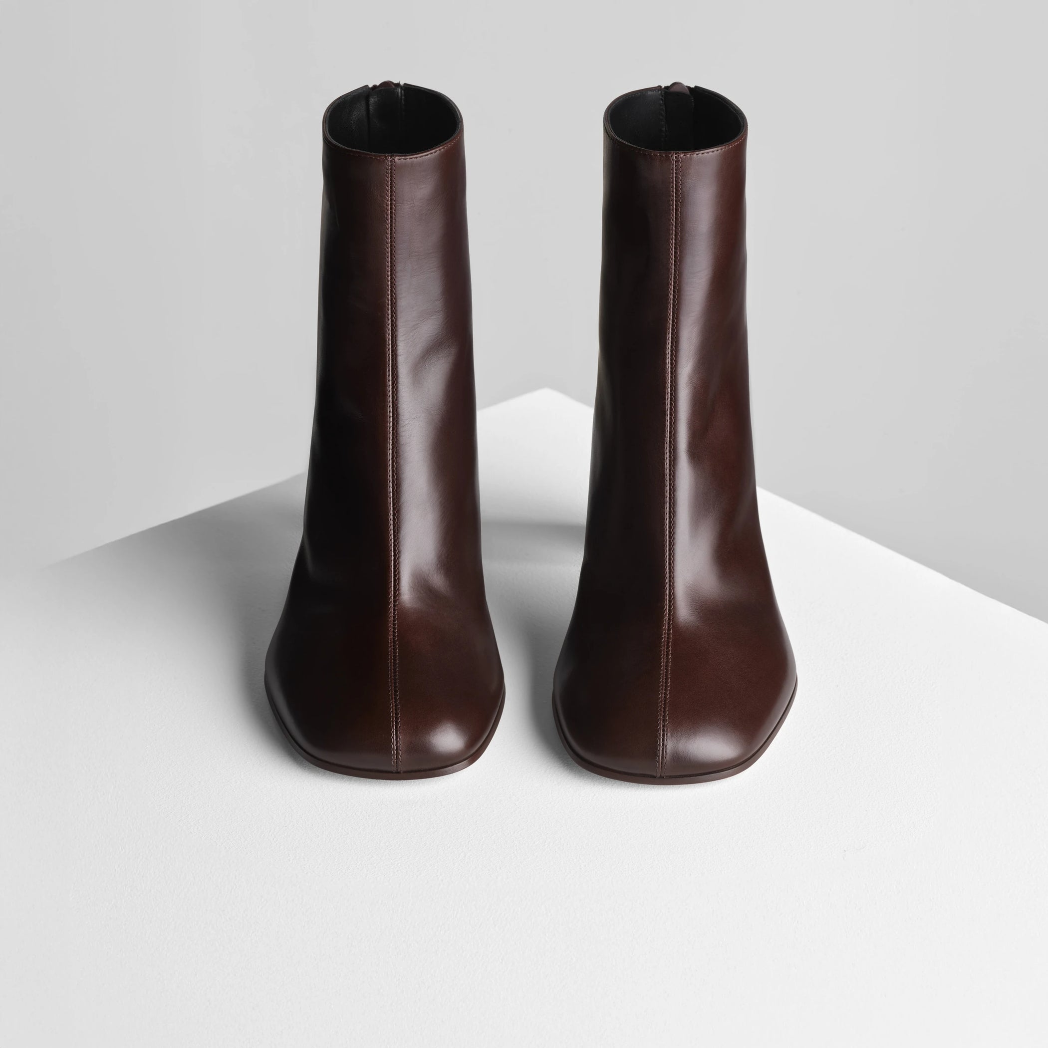 Front view of tug ankle boot in plum brown leather.