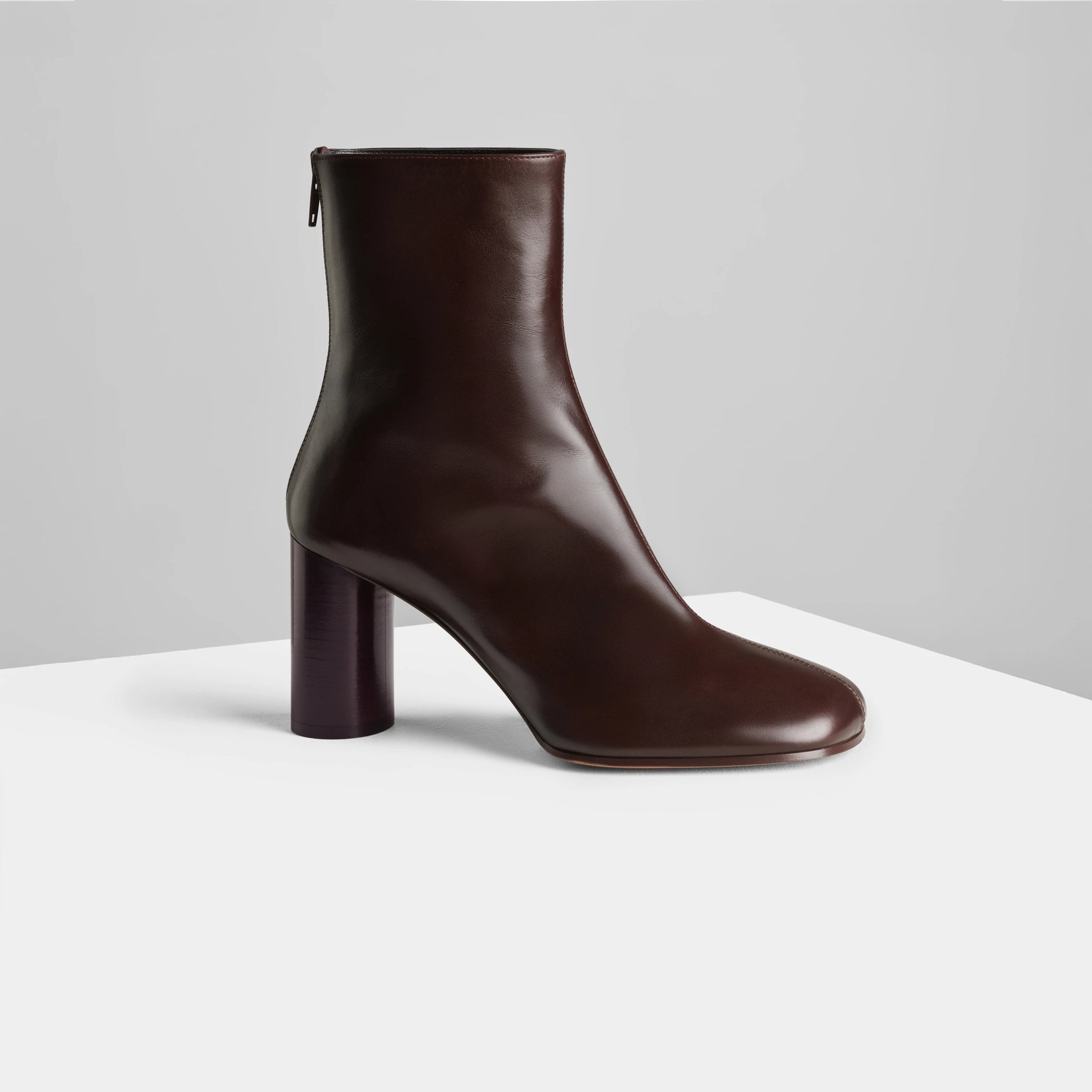 Side view of tug ankle boot in plum brown leather.