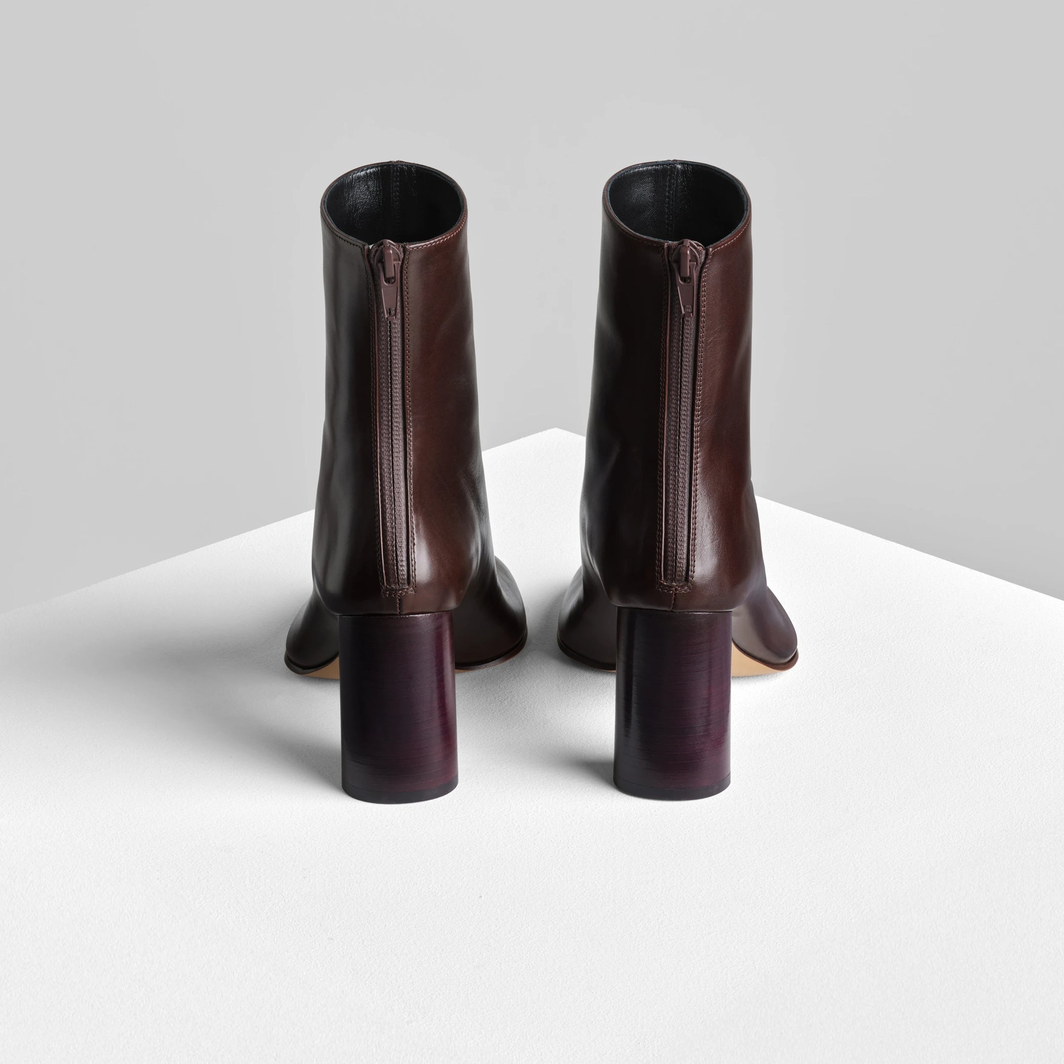 Back view of tug ankle boot in plum brown leather.