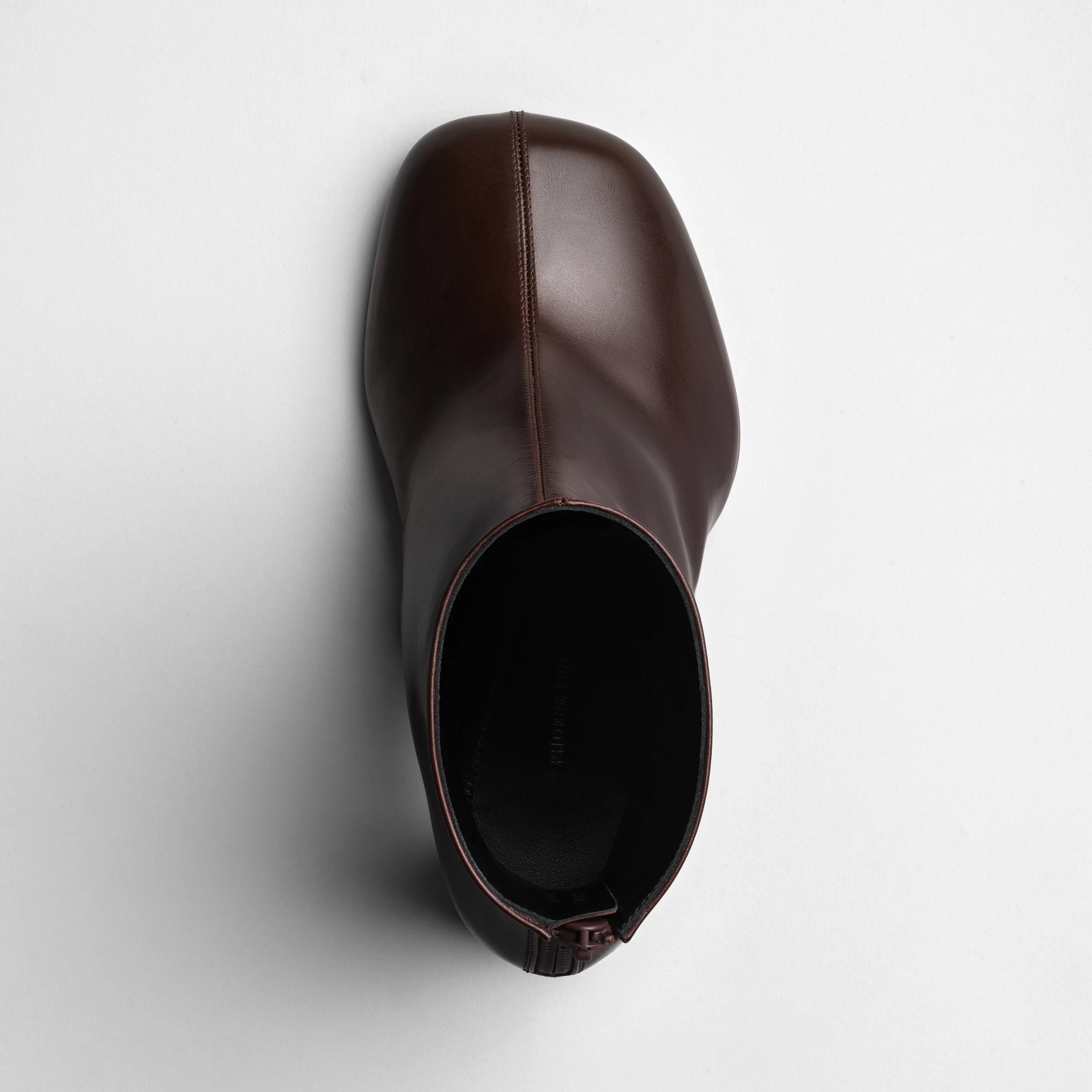 Top view of tug ankle boot in plum brown leather.