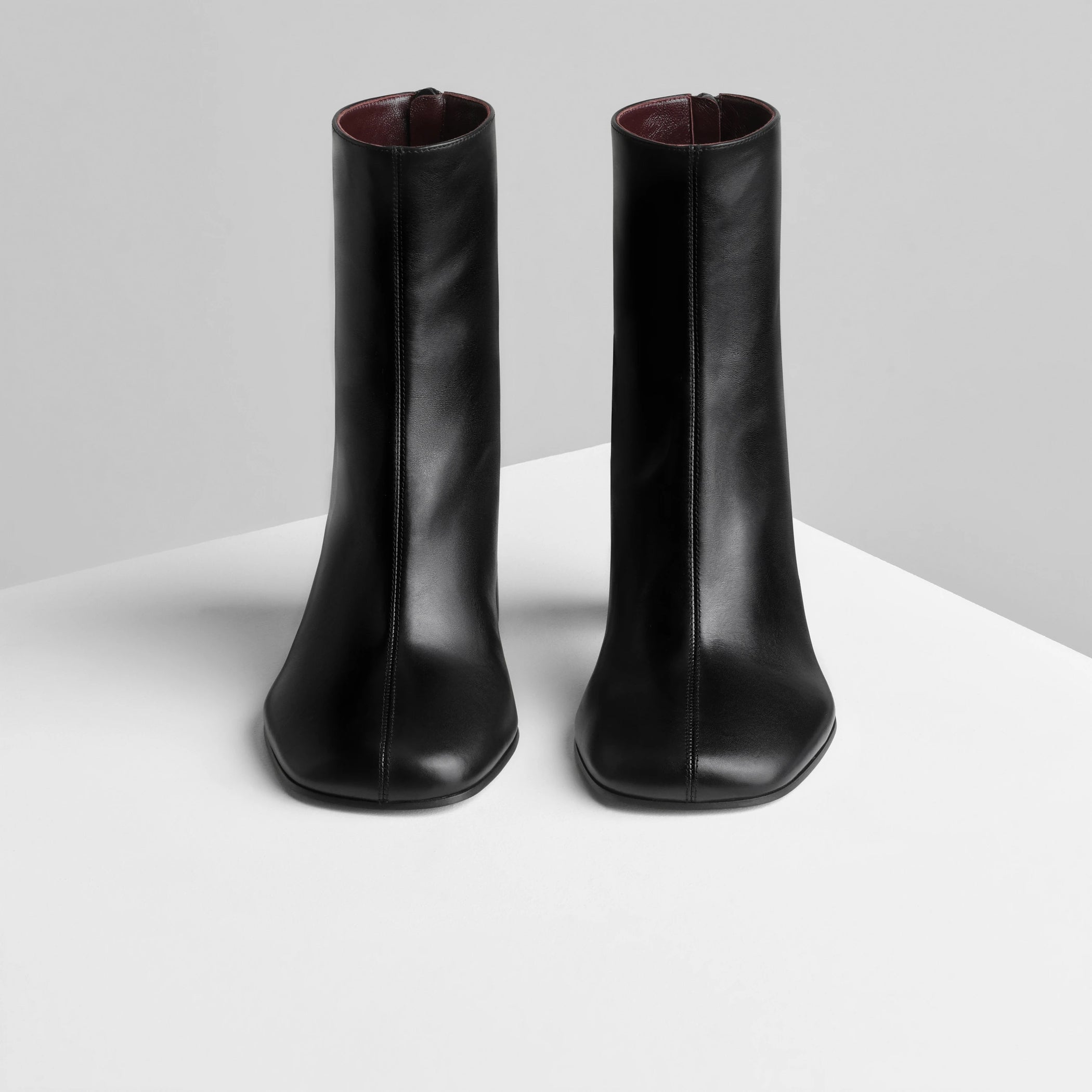 Front view of tug ankle boot in black leather.