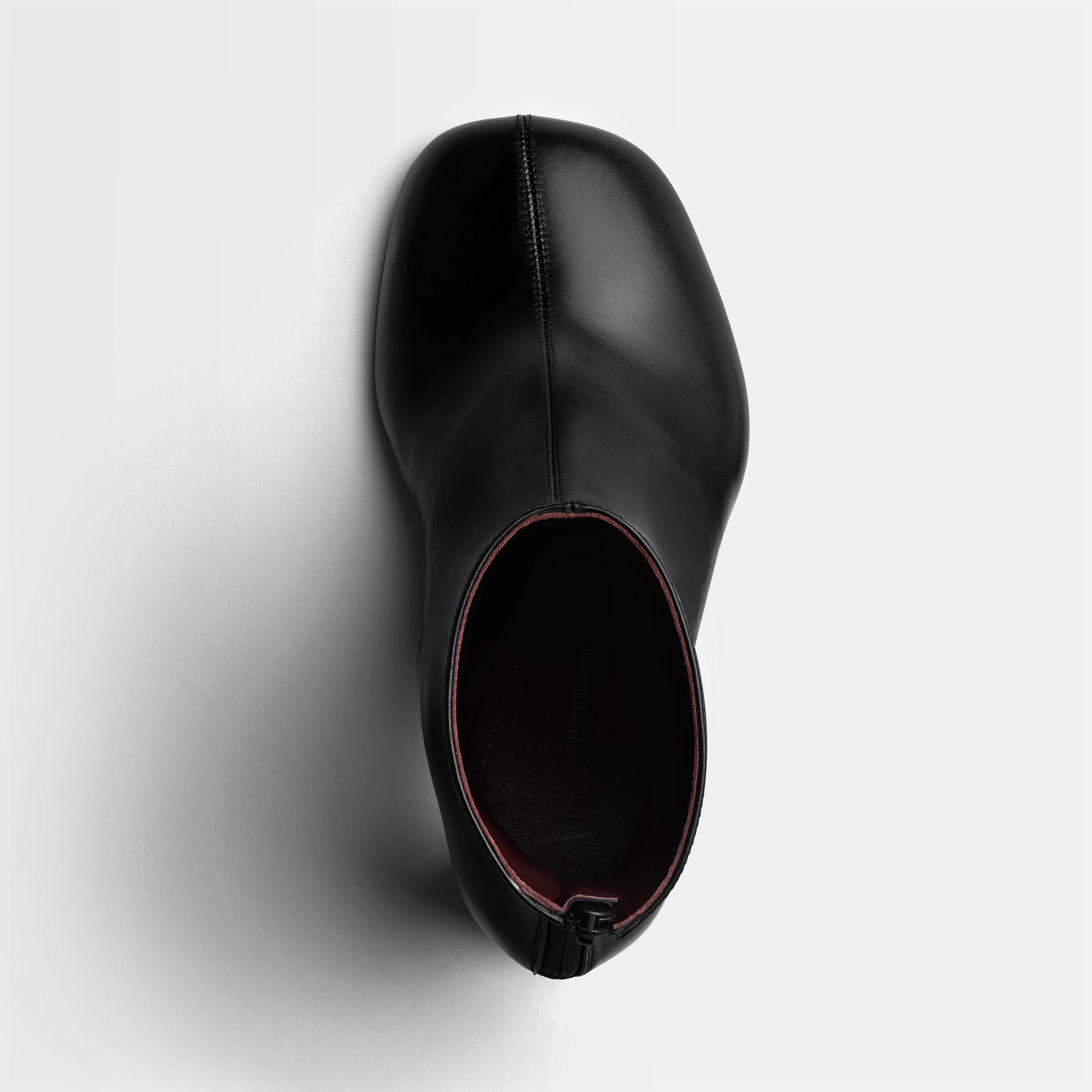 Top view of tug ankle boot in black leather.