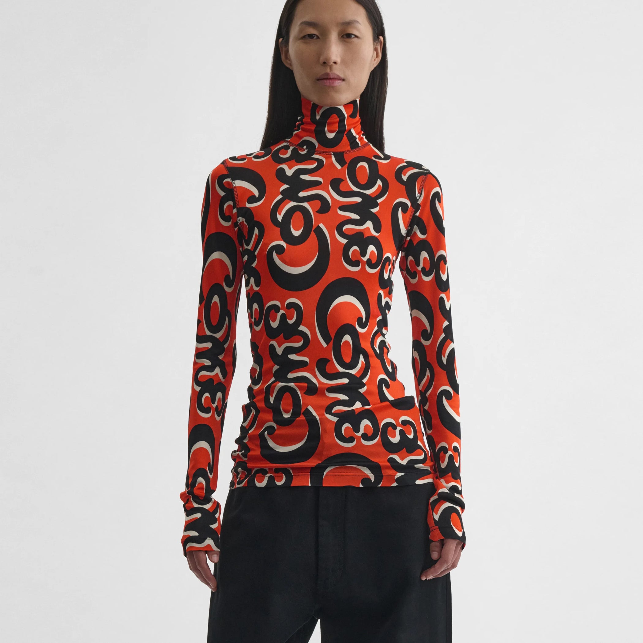 Front view of model wearing Doodle Top in red/black.