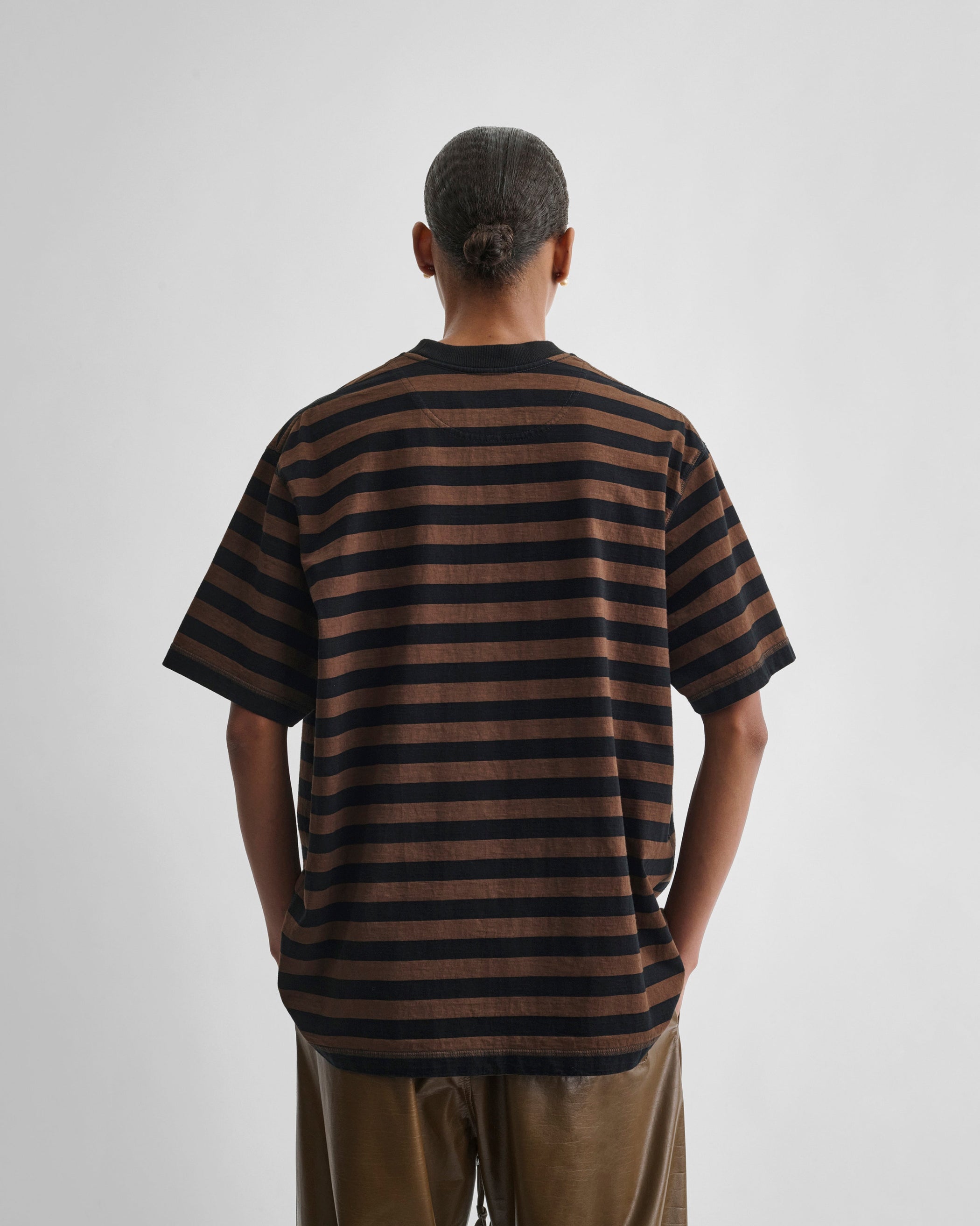 Back view of model wearing CLASSIC TEE in black/brown cotton