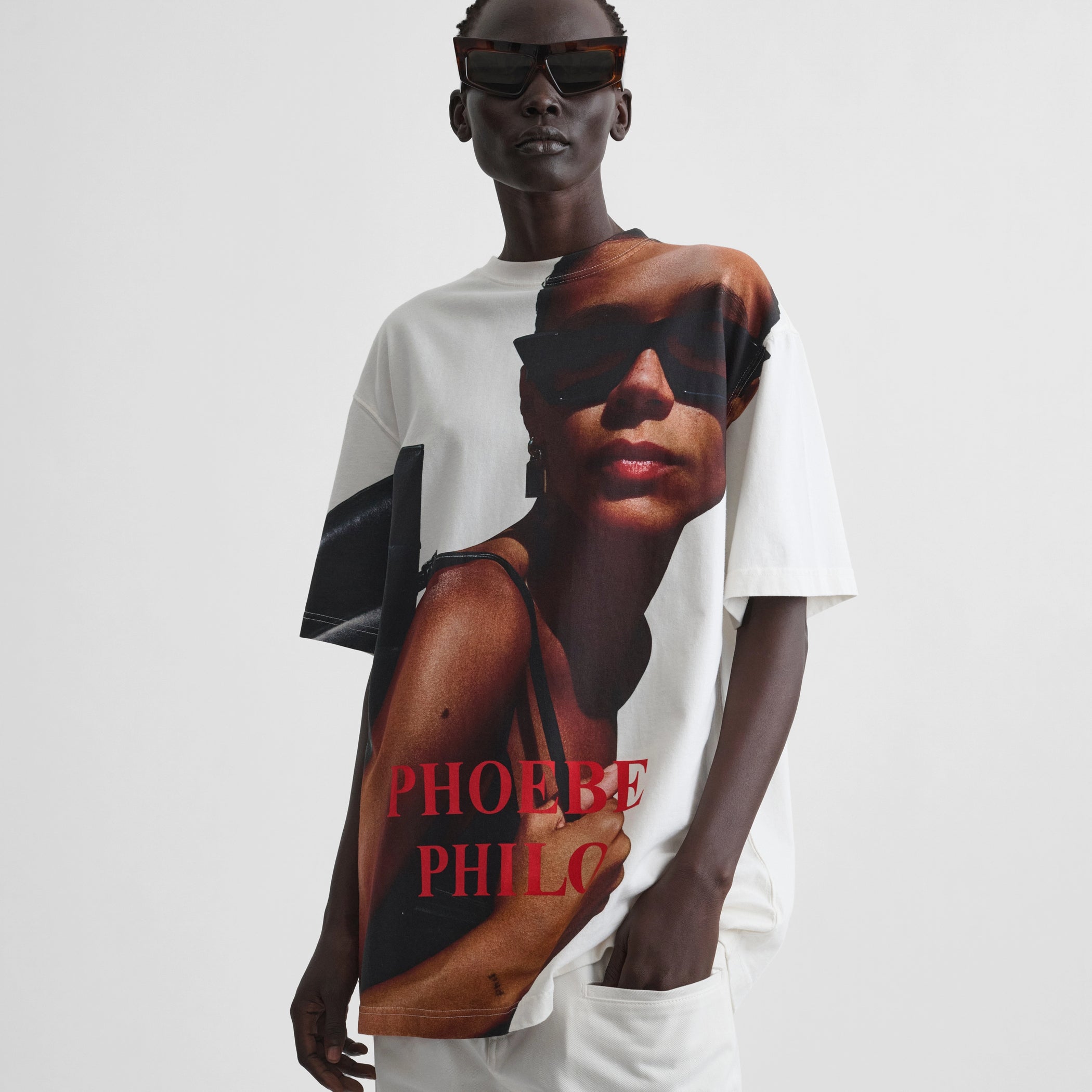 Front view of model wearing zine t-shirt in face print cotton