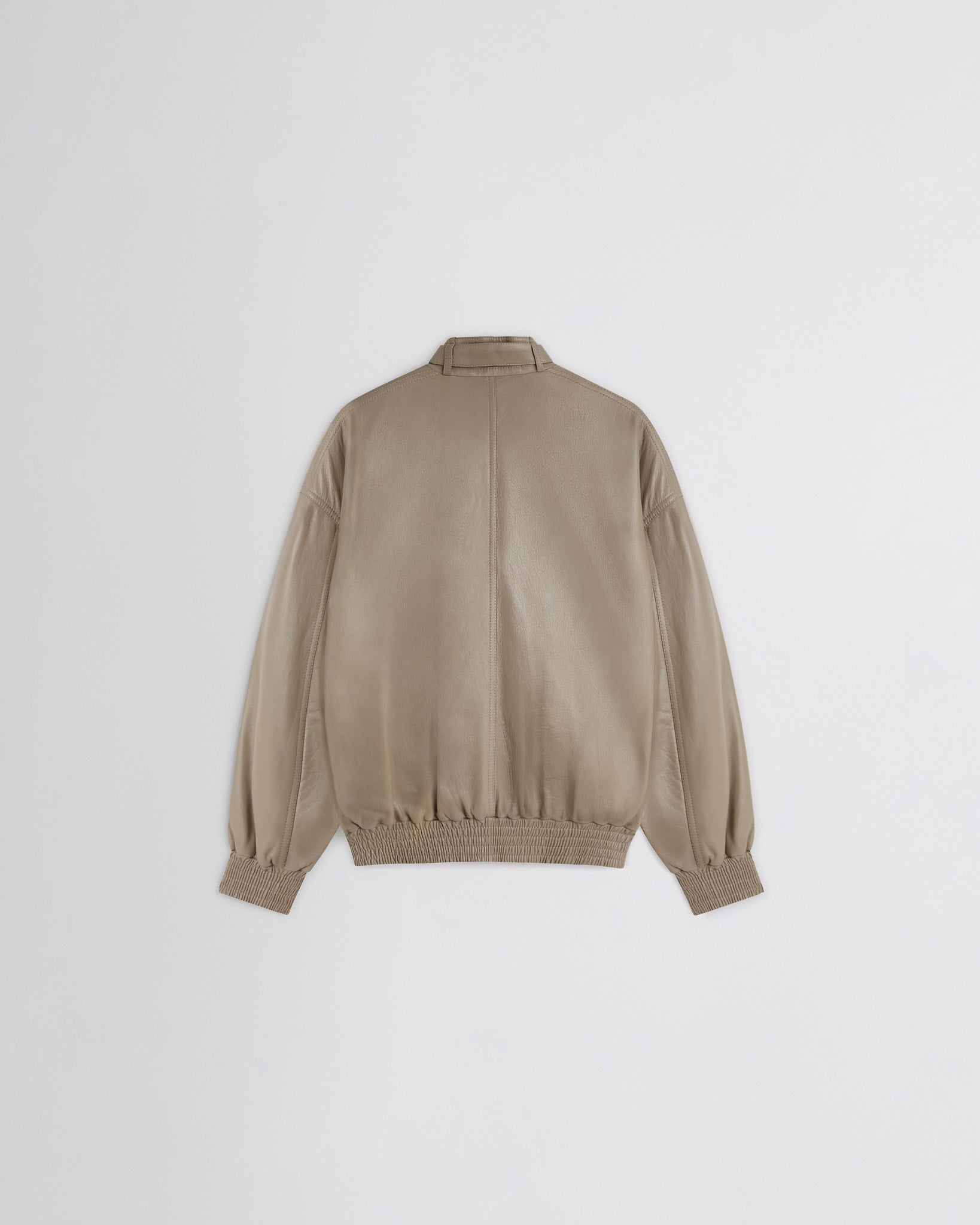 Flat back view of attachable scarf in mastic leather