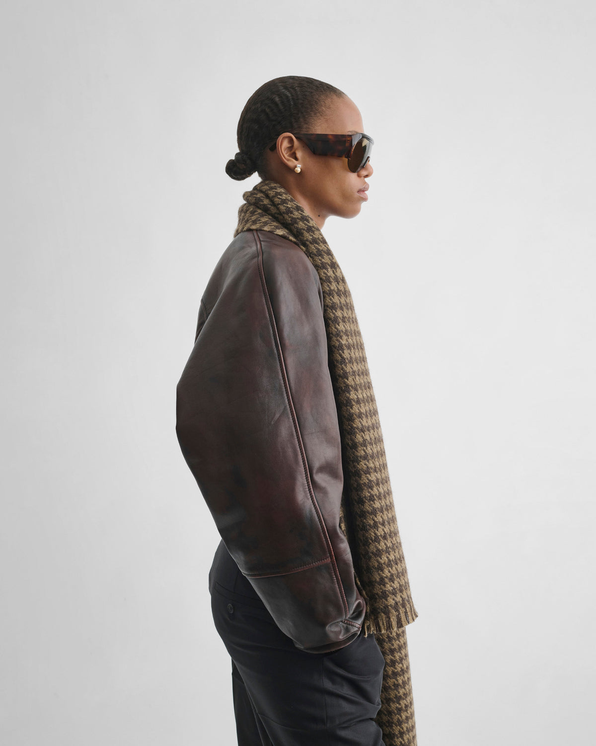 Side view of model wearing SHRUNK BOMBER in conker leather