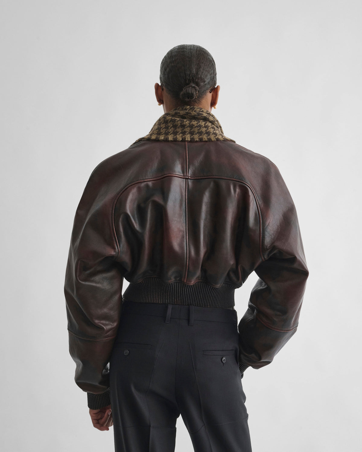 Back view of model wearing SHRUNK BOMBER in conker leather