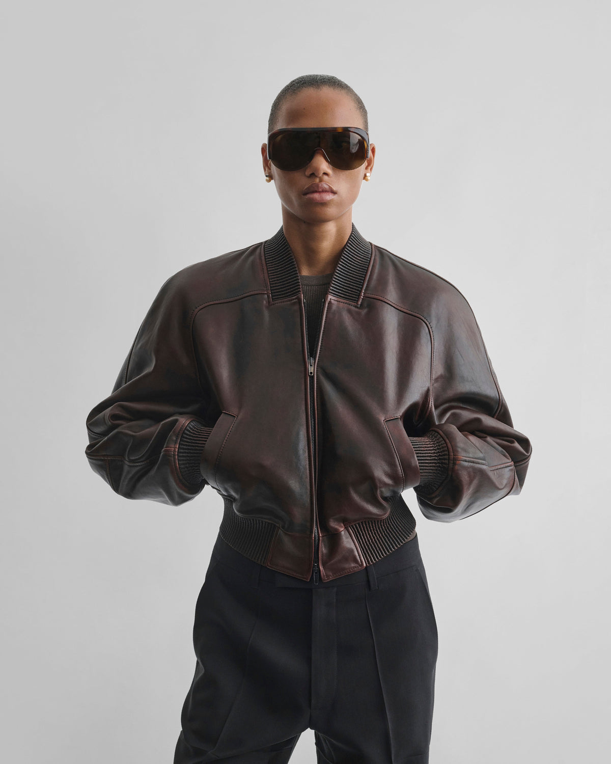 Front view of model wearing SHRUNK BOMBER in conker leather