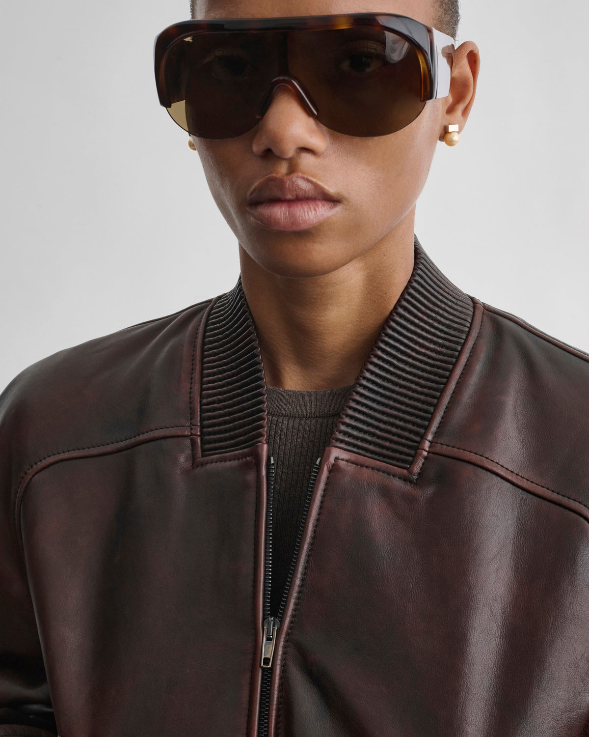 Front detail view of model wearing SHRUNK BOMBER in conker leather