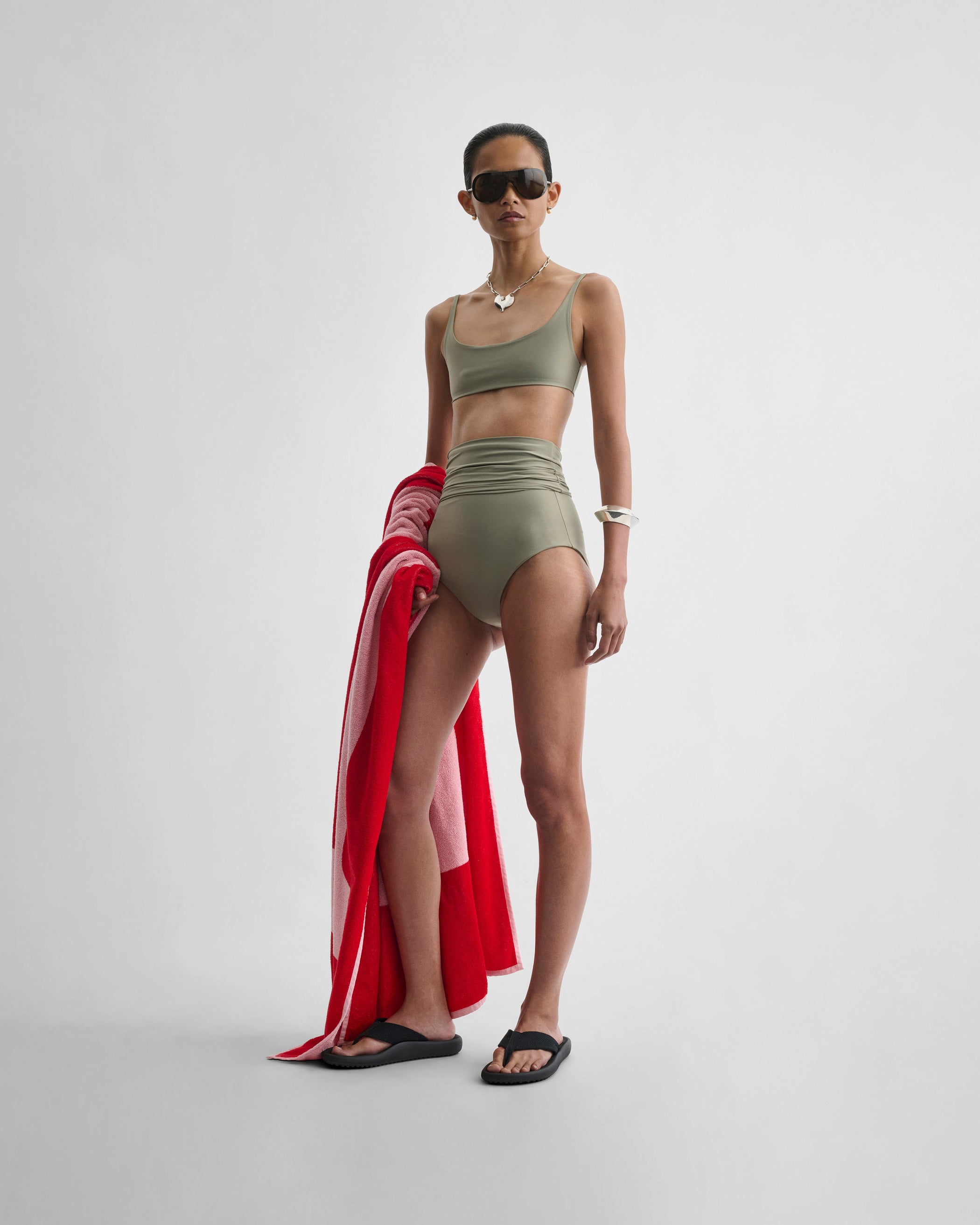 Front view of model wearing FOLD DOWN BIKINI BOTTOMS in light sage polyamide