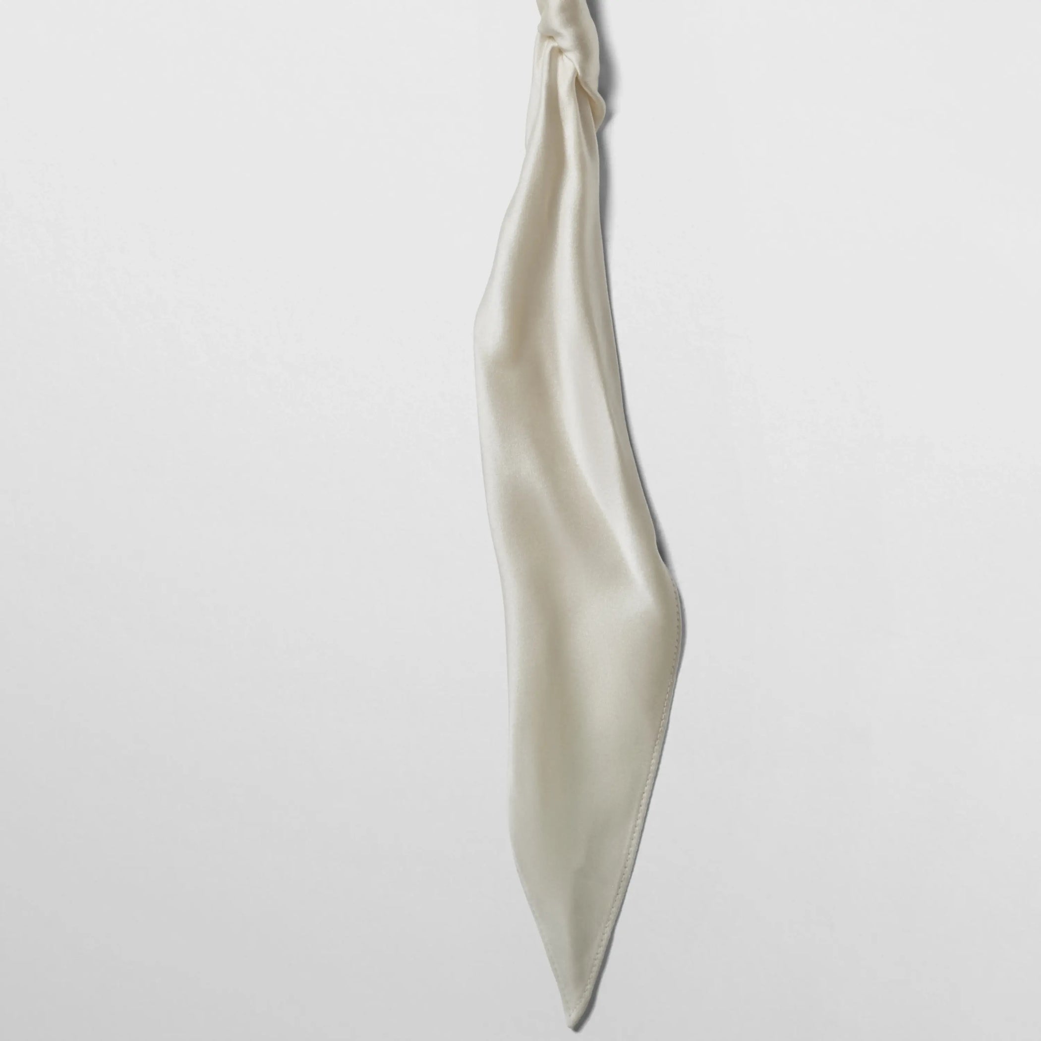 Close up detail view of twisted scarf in cream satin