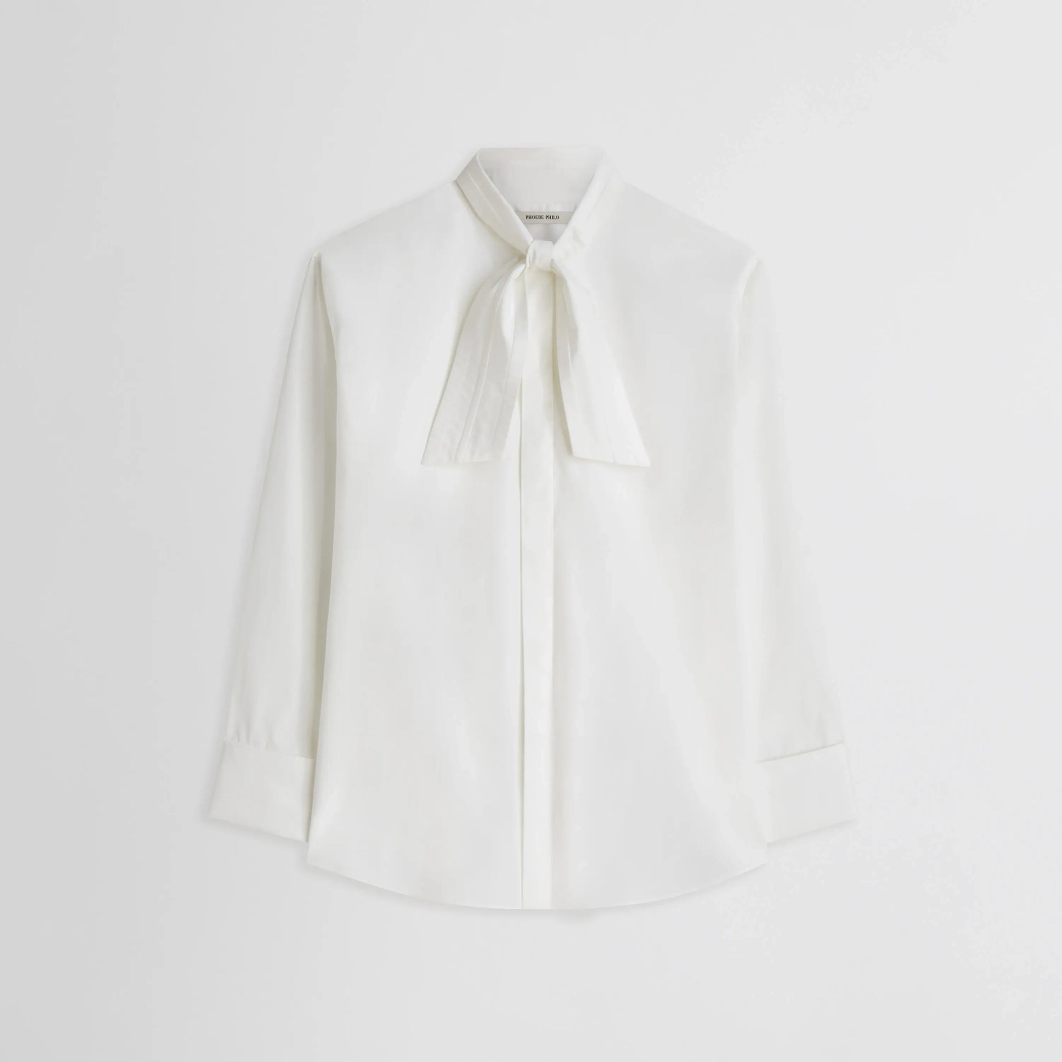 Front flat lay view of Tie Neck Shirt in white. 