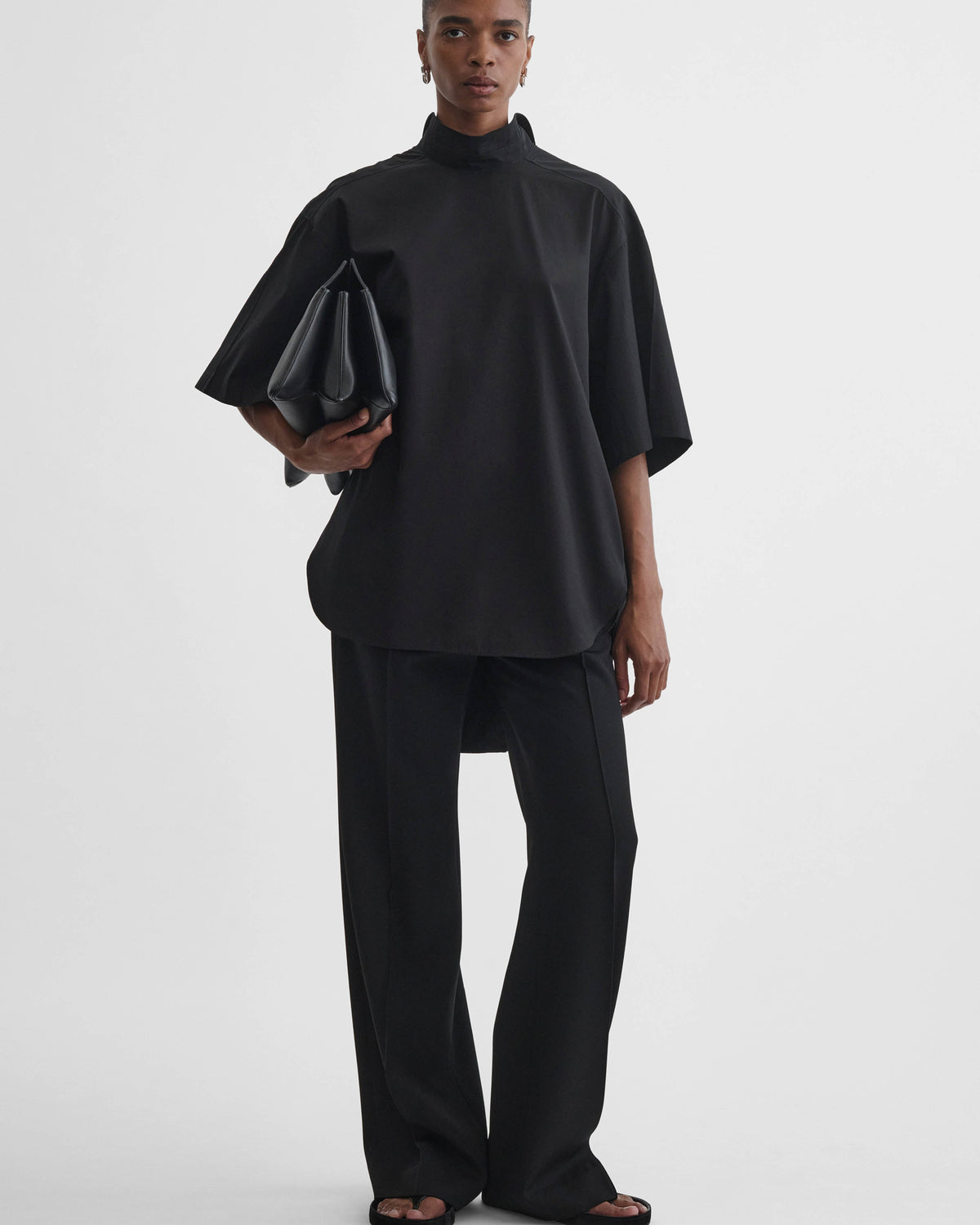 Front view of model wearing TIE NECK SHORT SLEEVE SHIRT in black cotton