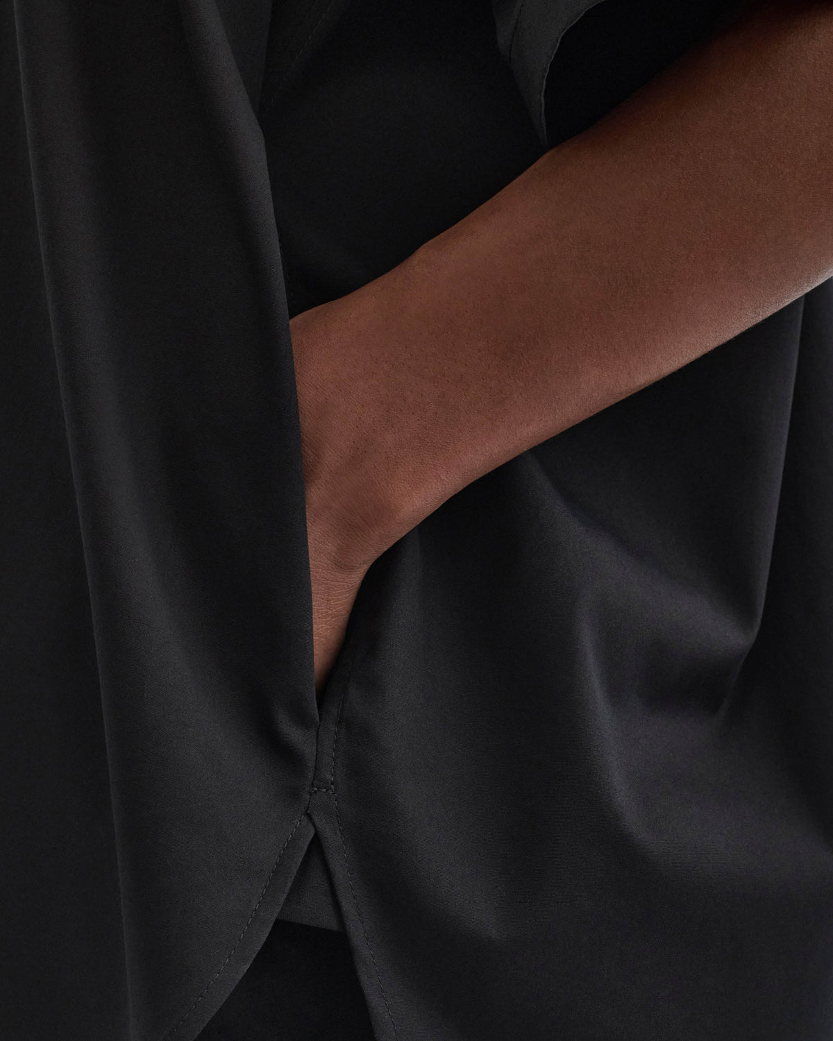 Detail view of model wearing TIE NECK SHORT SLEEVE SHIRT in black cotton