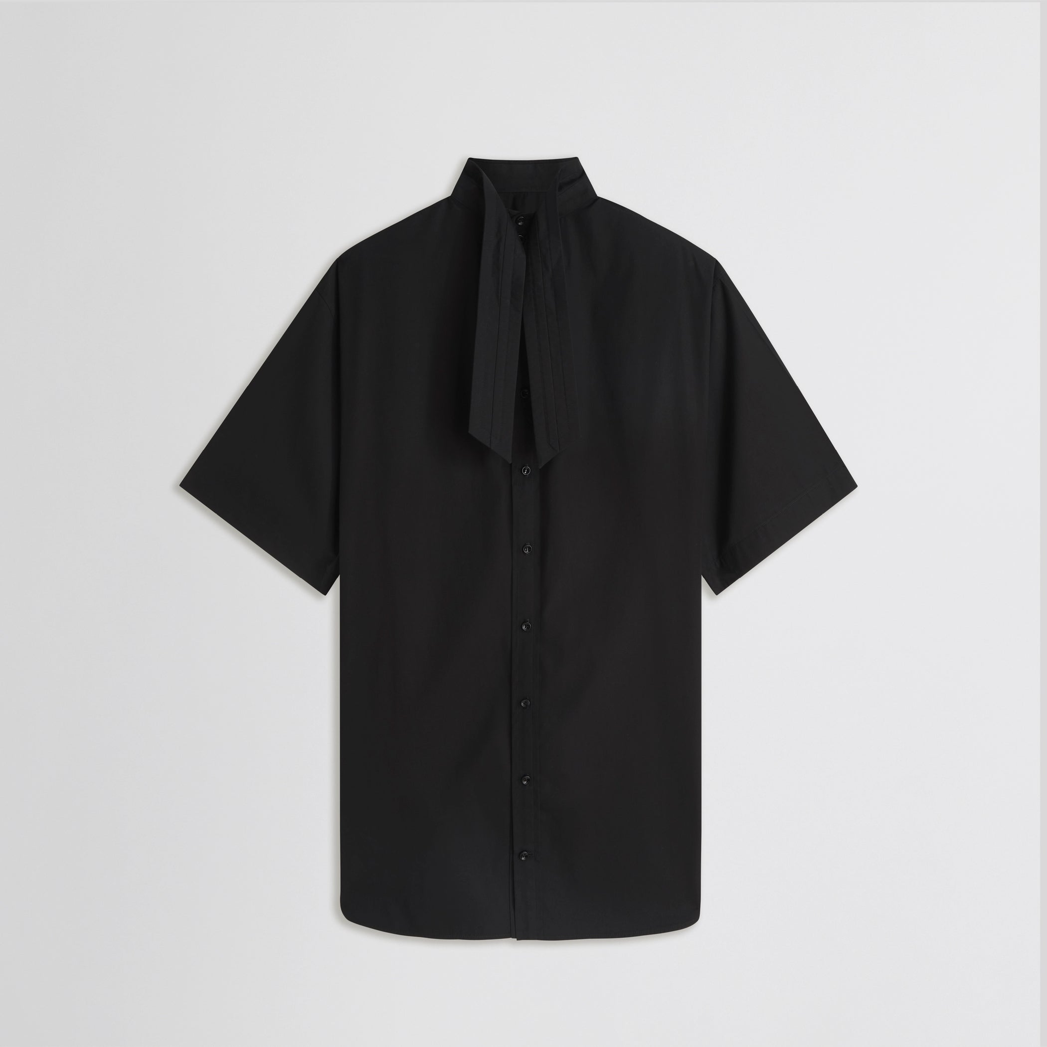Flat back view of tie neck short sleeve shirt in black cotton