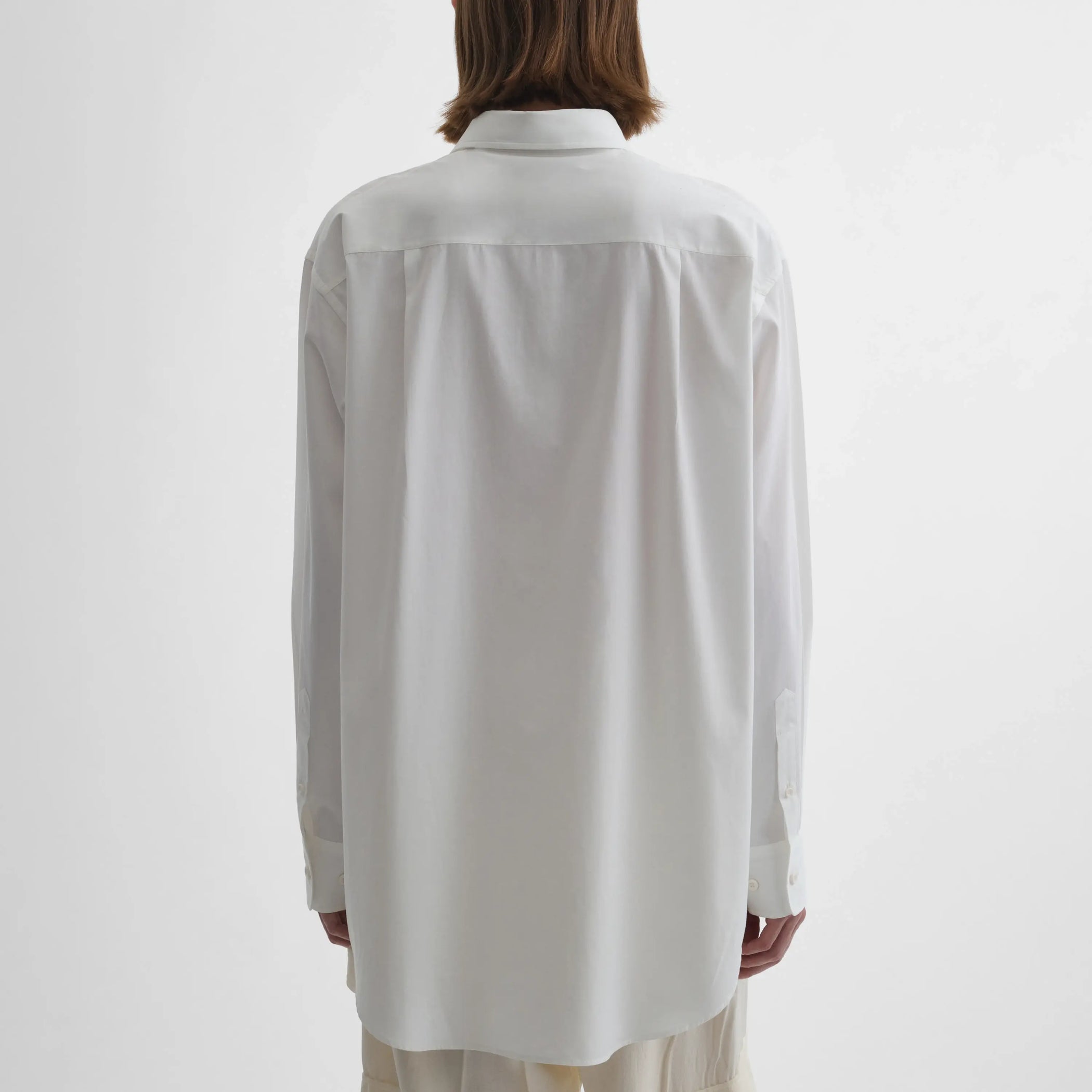 Back view of model wearing Sharp Collar Shirt in white.
