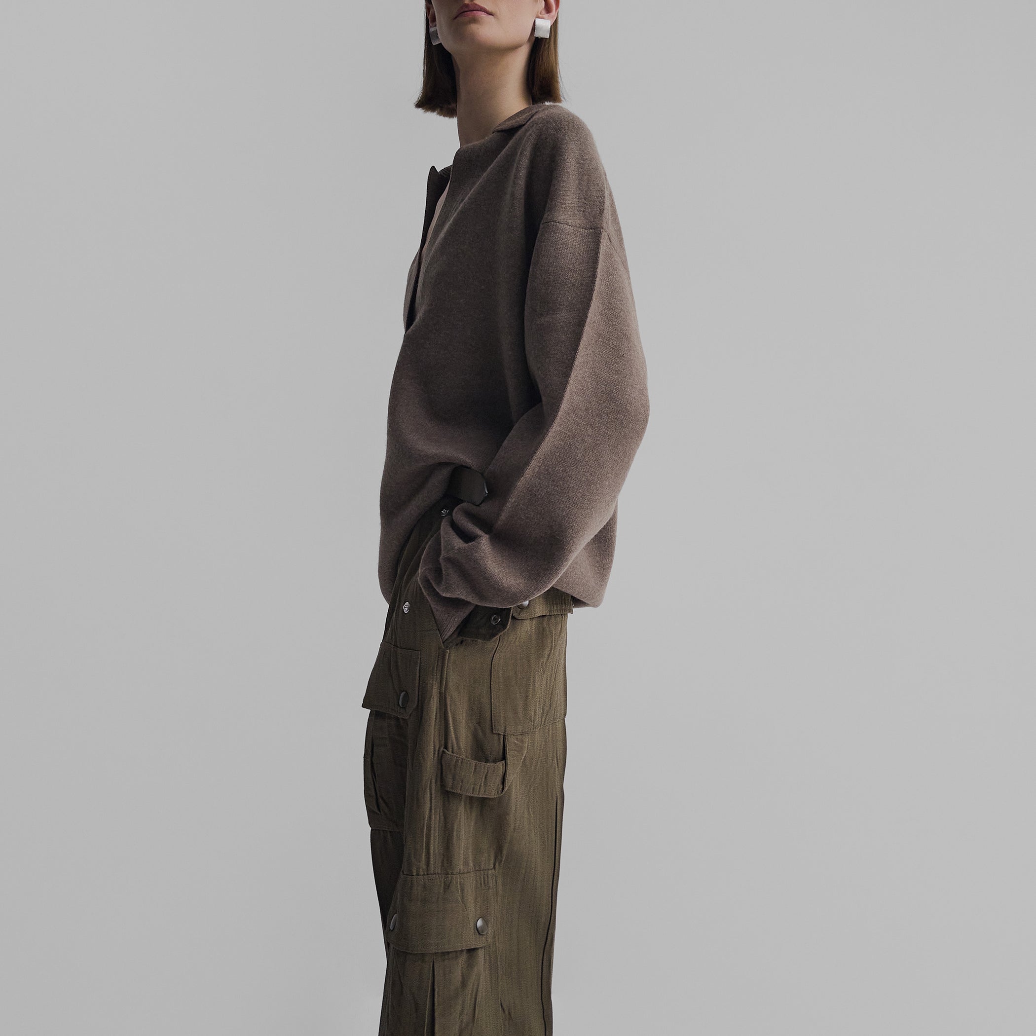 Side view of model wearing SOFT SHIRT COLLAR JUMPER in dun