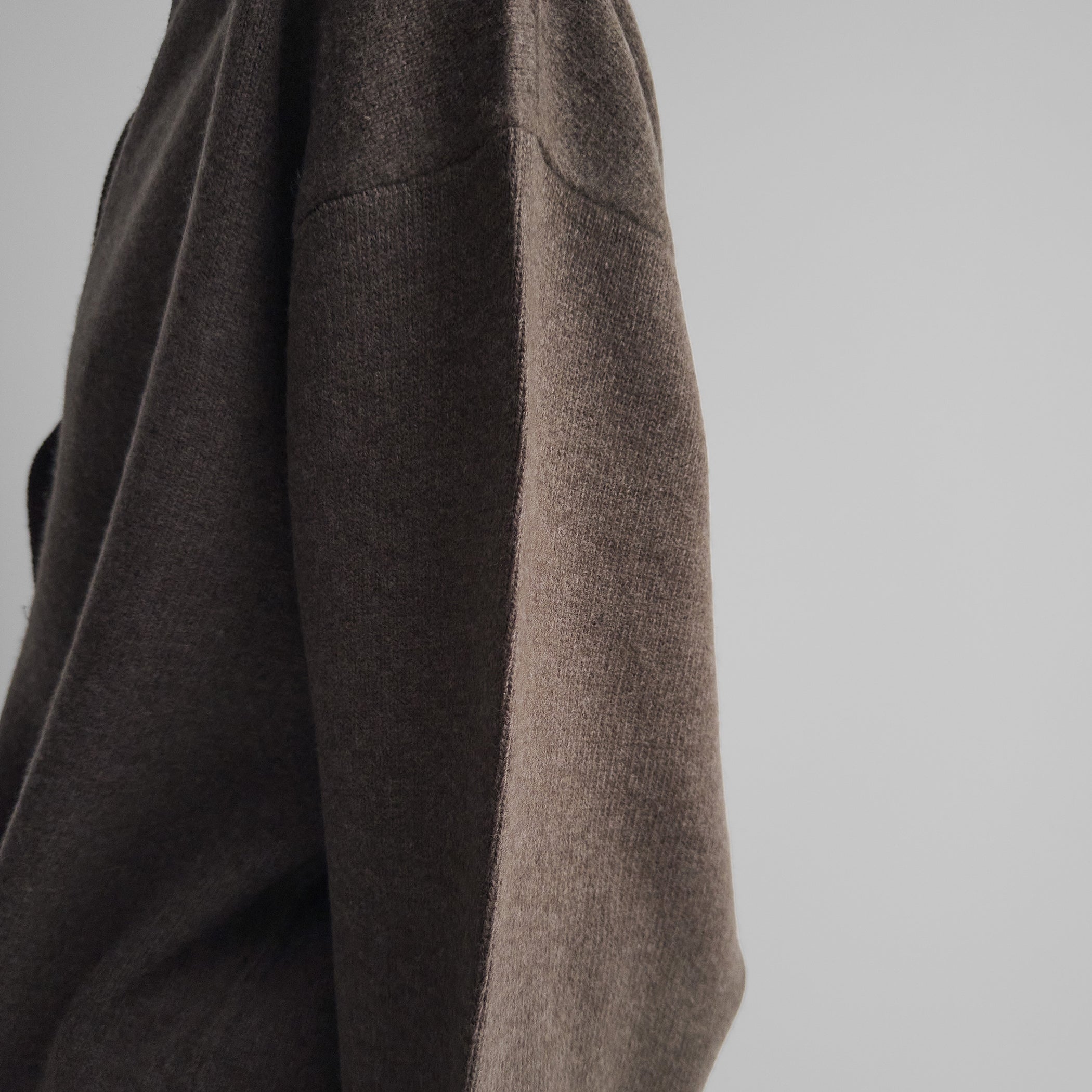 Detail view of model wearing SOFT SHIRT COLLAR JUMPER in dun