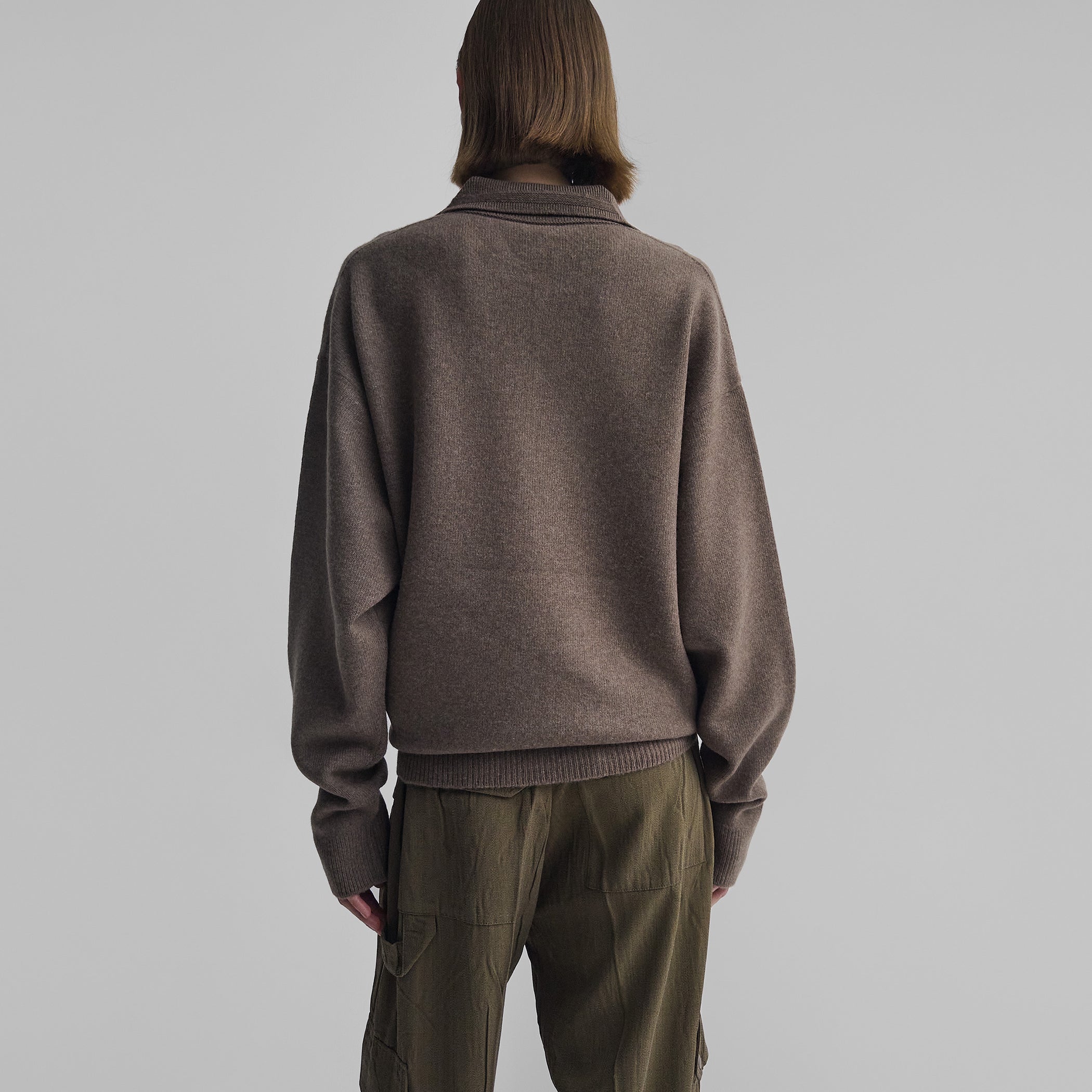 Back view of model wearing SOFT SHIRT COLLAR JUMPER in dun