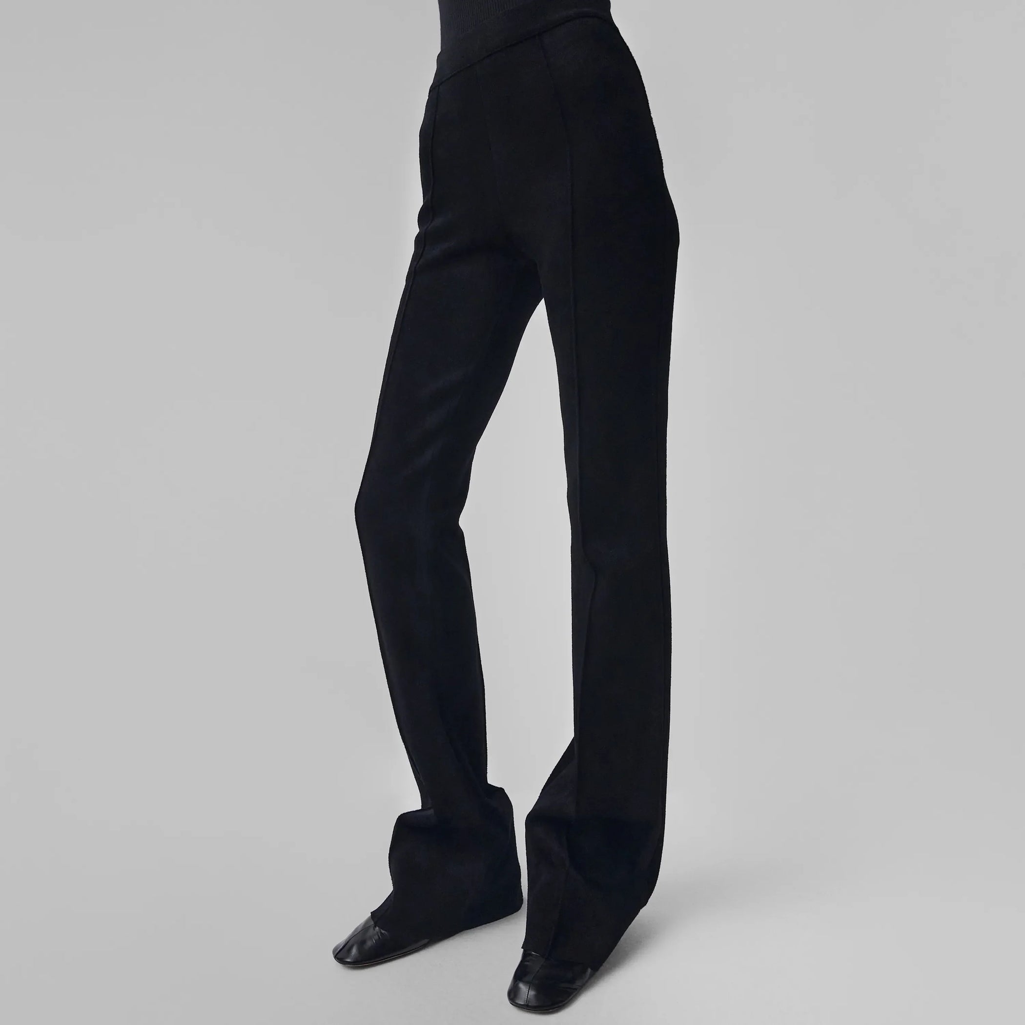 Front view of model wearing CHENILLE TROUSERS in black technical polyester
