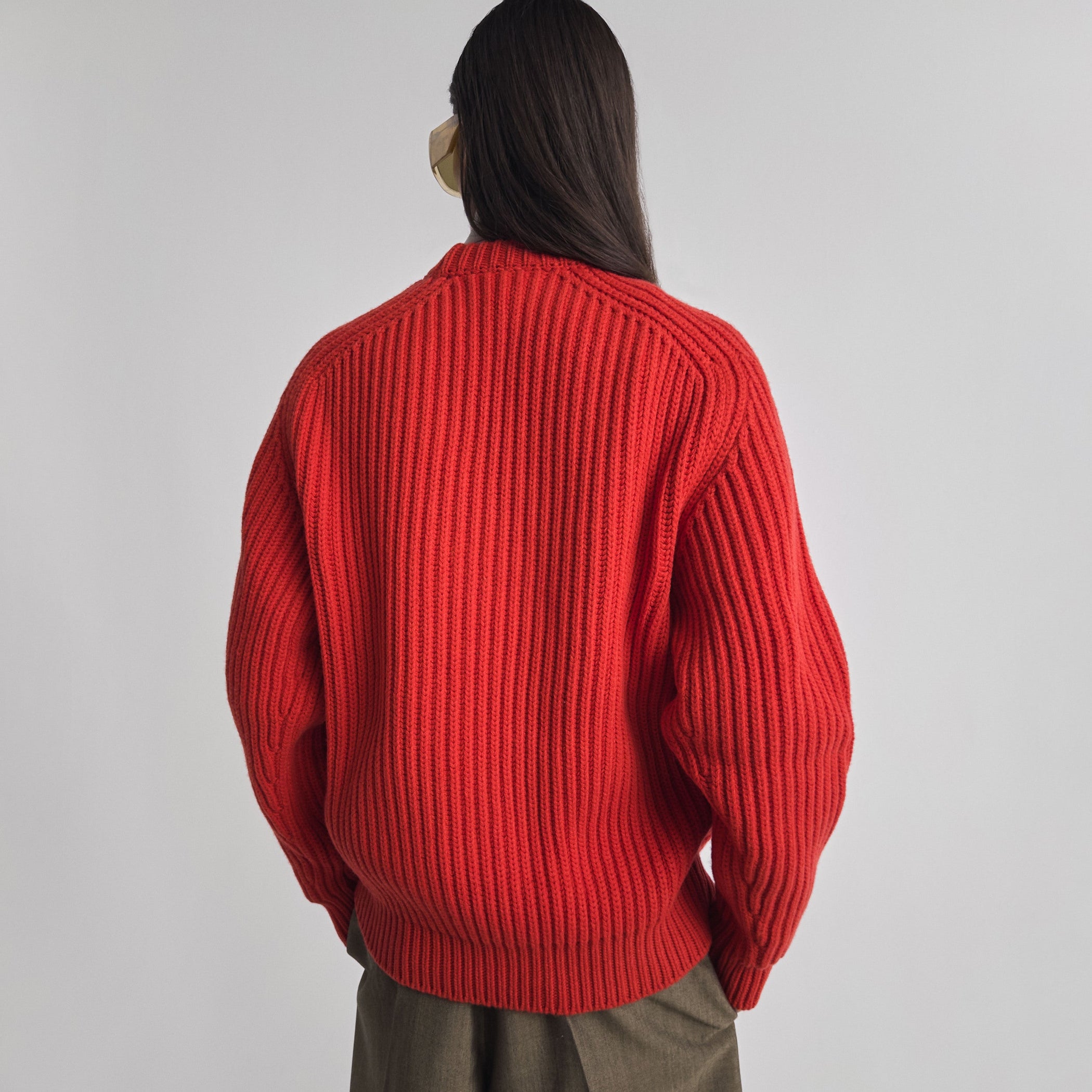 Back view of model wearing CREW-NECK JUMPER in bright red english rib cashmere