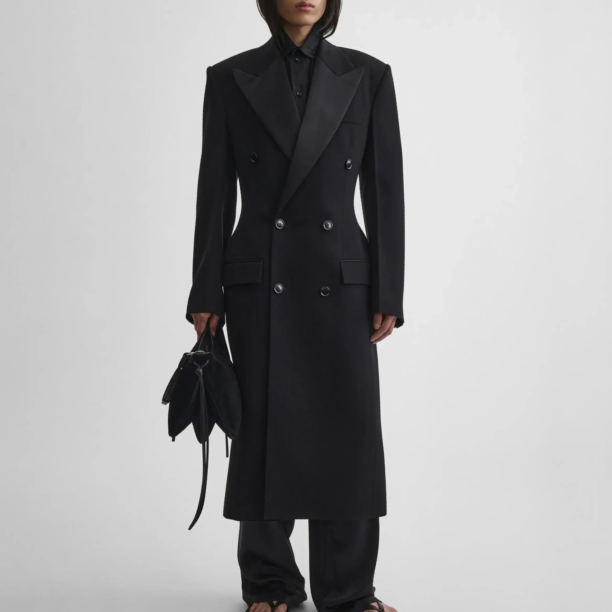 Front view of model wearing TAILORED COAT WITH DROPPED WAIST in black wool