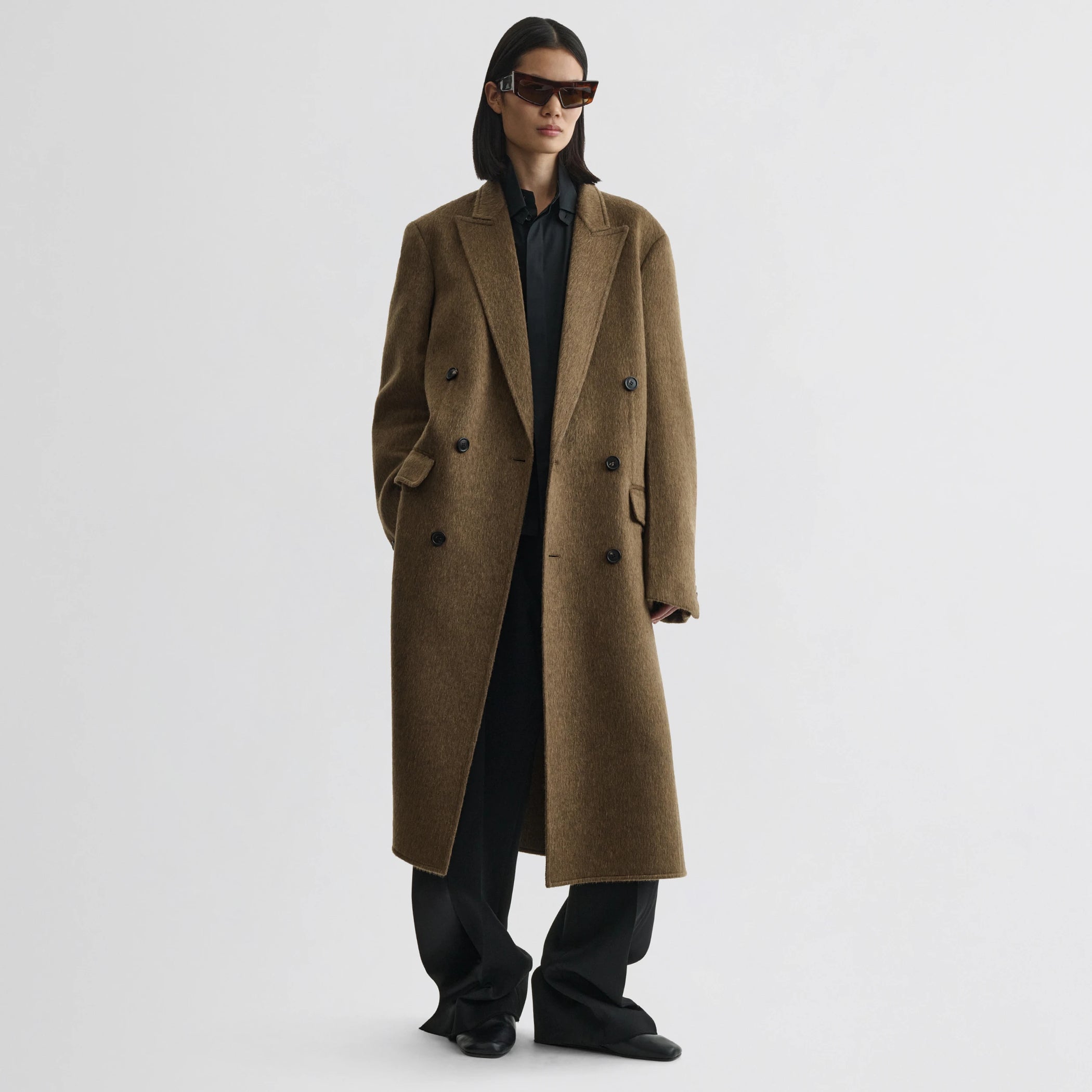 Front view of model wearing man&#39;s coat in bronze khaki wool mohair.