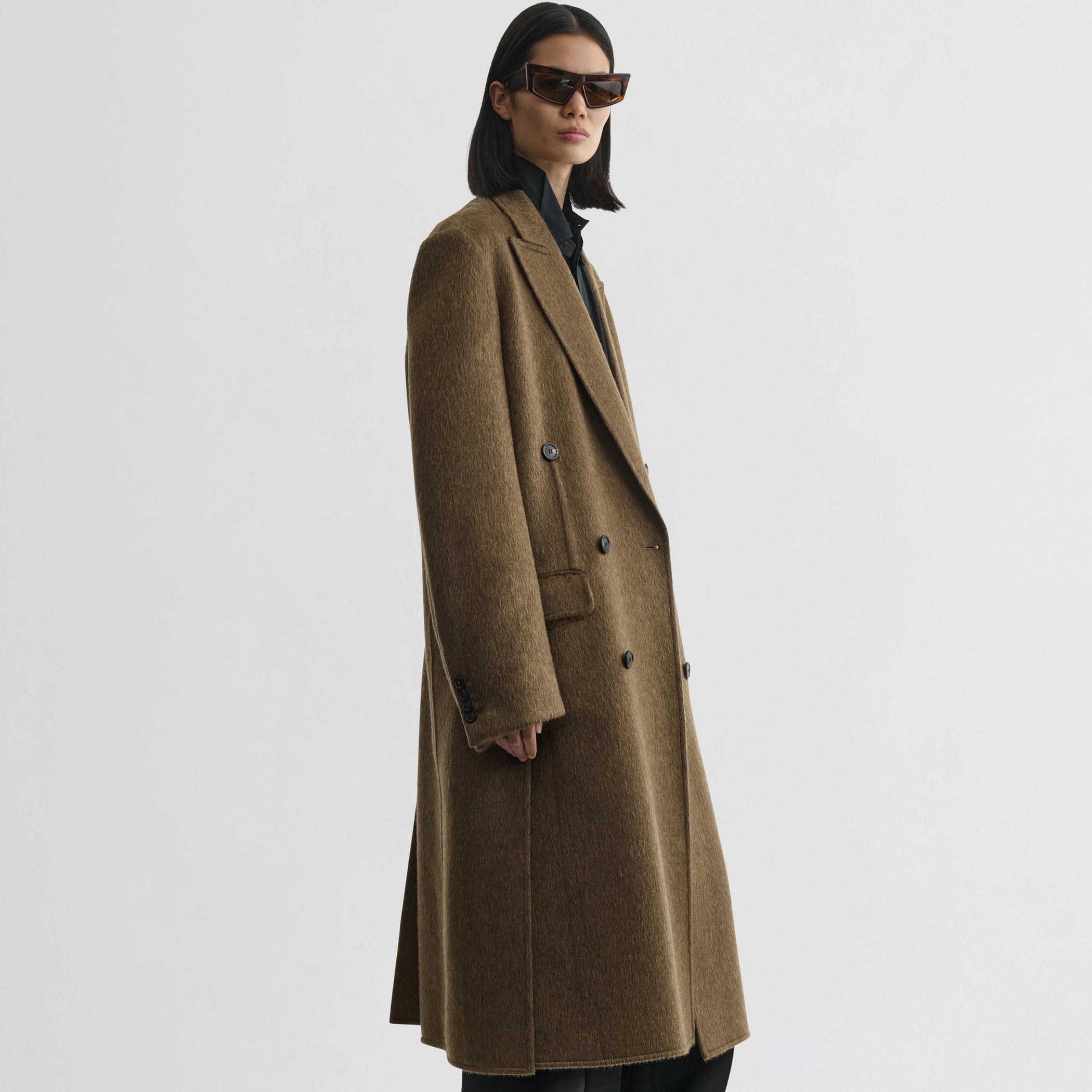 Front view of model wearing man&#39;s coat in bronze khaki wool mohair.
