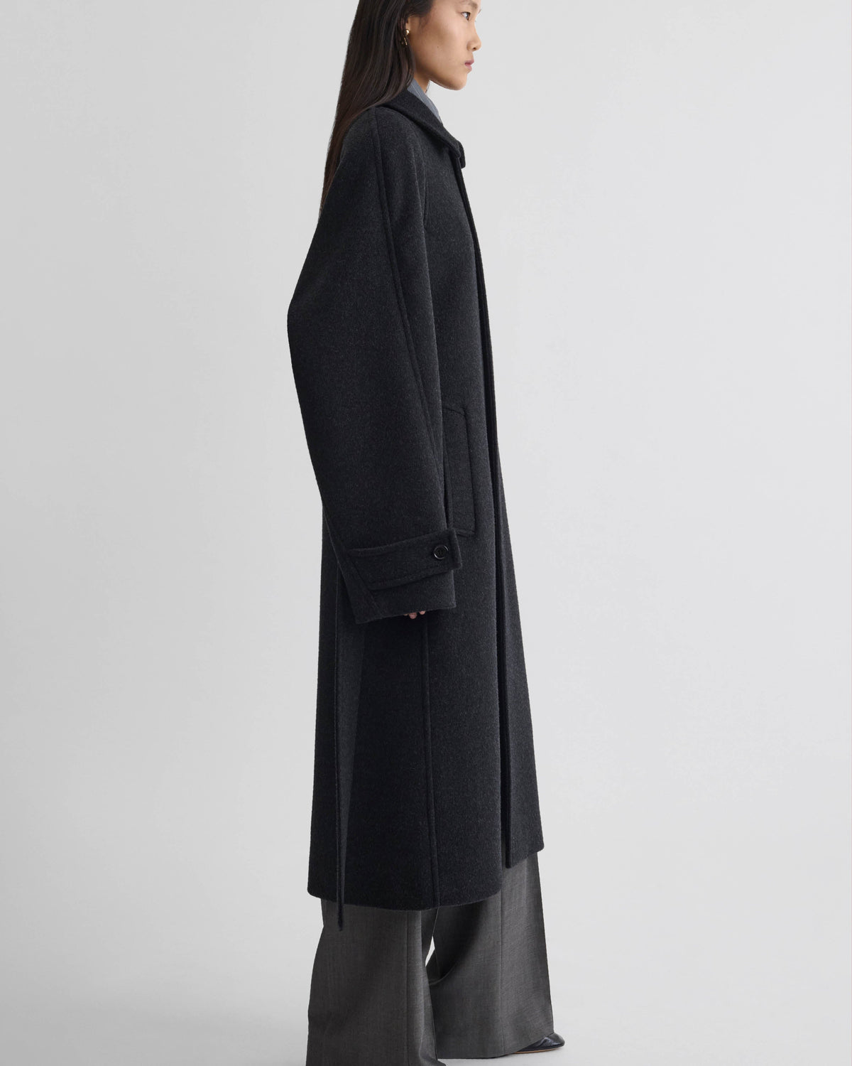 Side view of model wearing ROUNDED SHOULDER COAT in anthracite wool cashmere