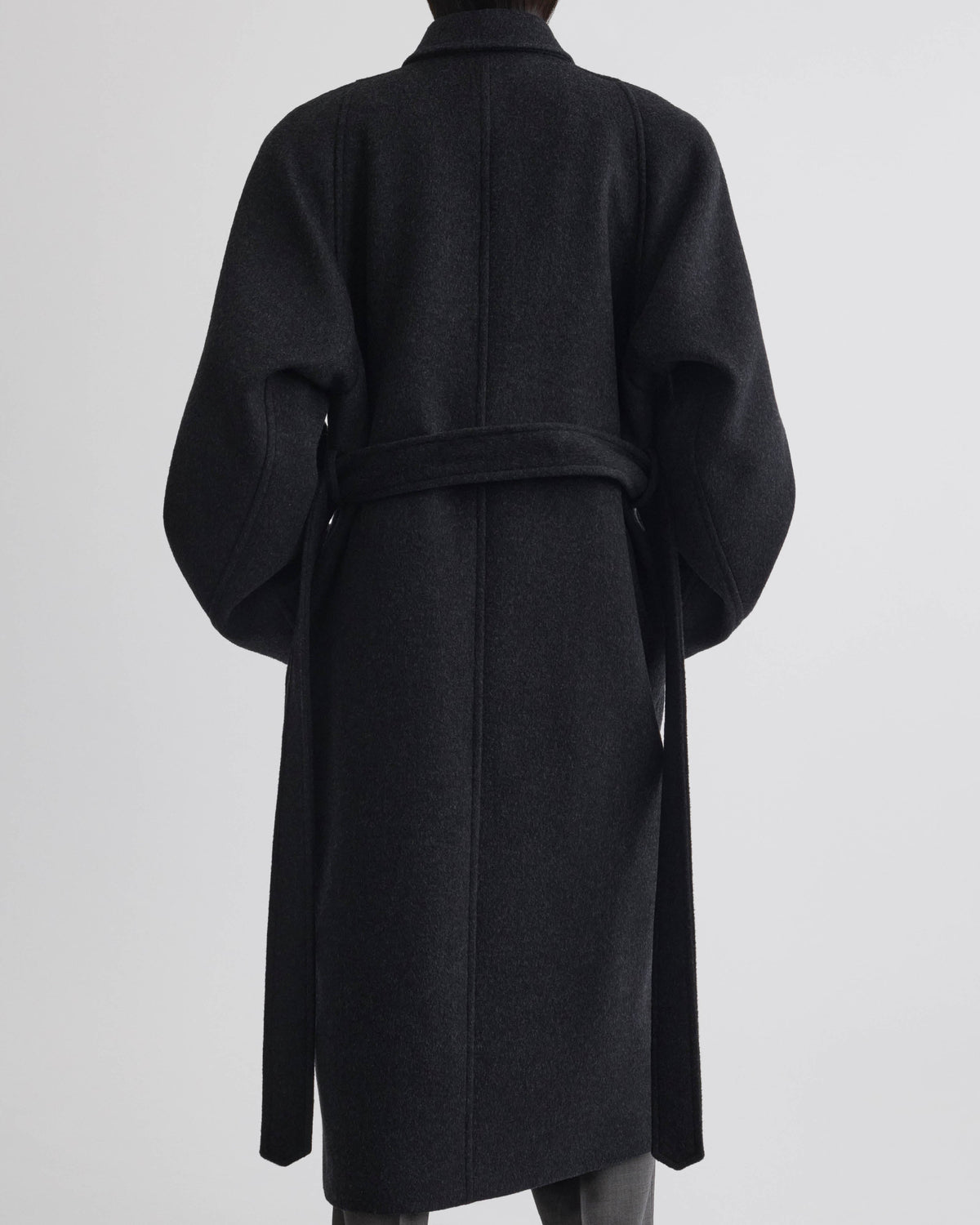 Back view of model wearing ROUNDED SHOULDER COAT in anthracite wool cashmere