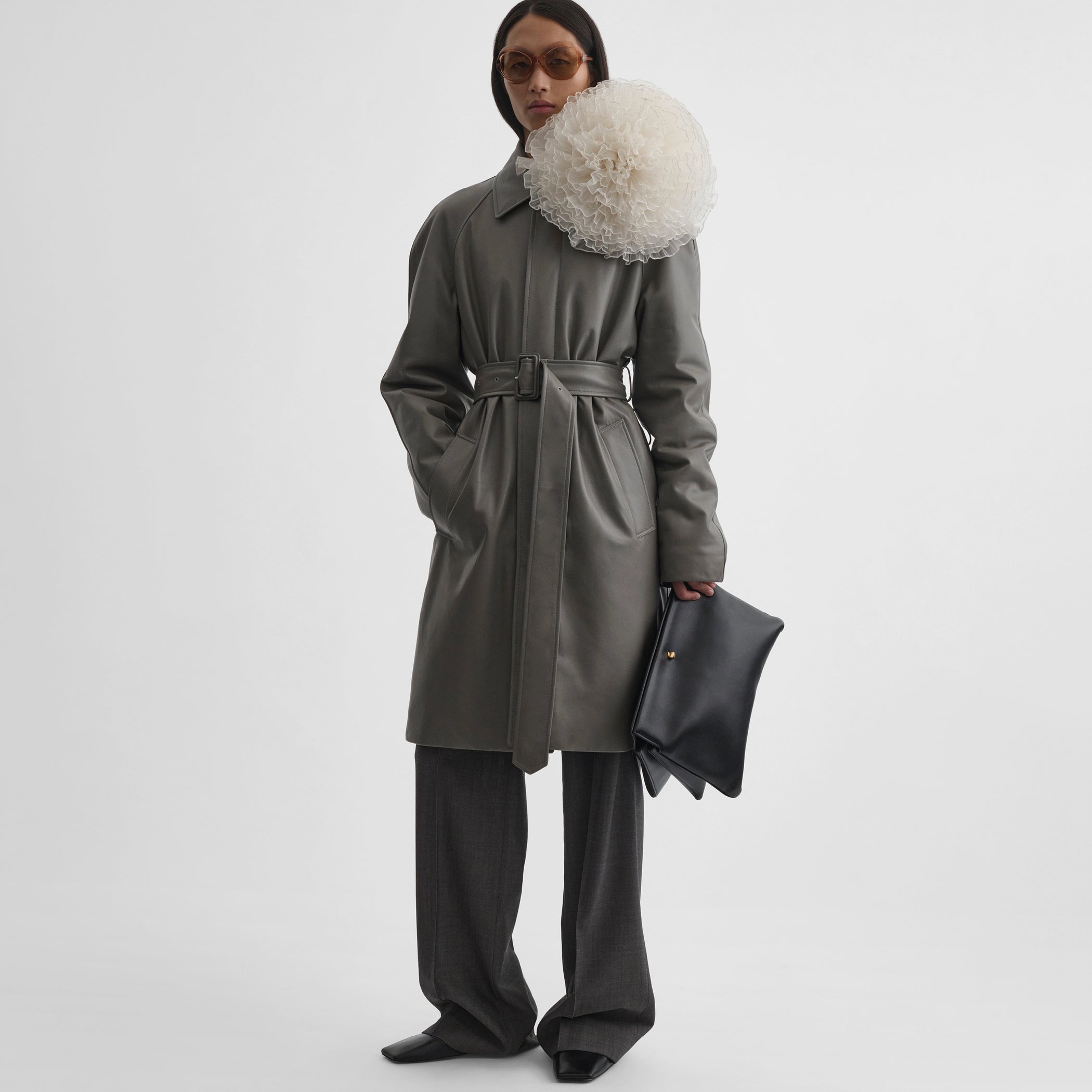 Front view of model wearing the car coat in fog