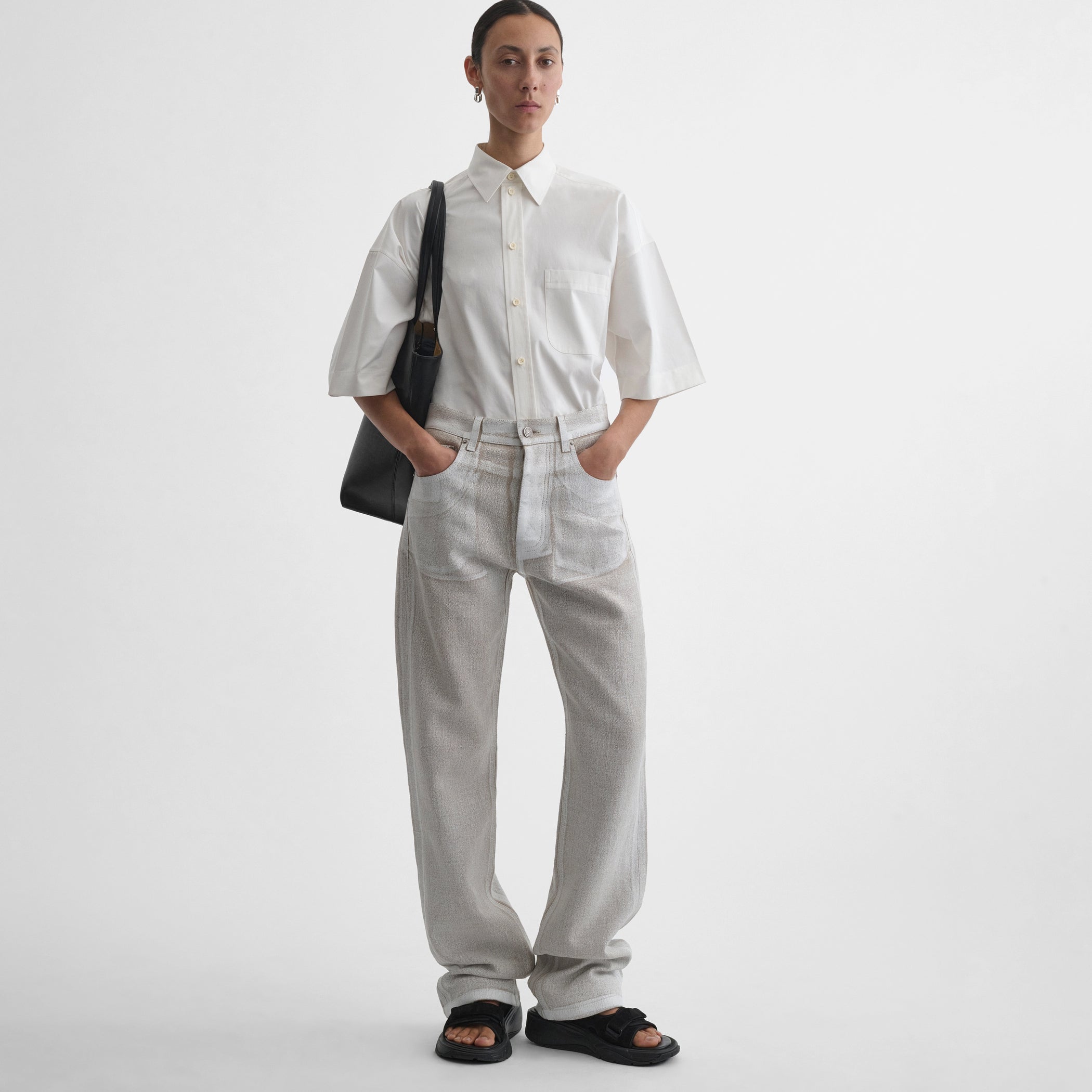 Front view of model wearing the classic jeans in hay