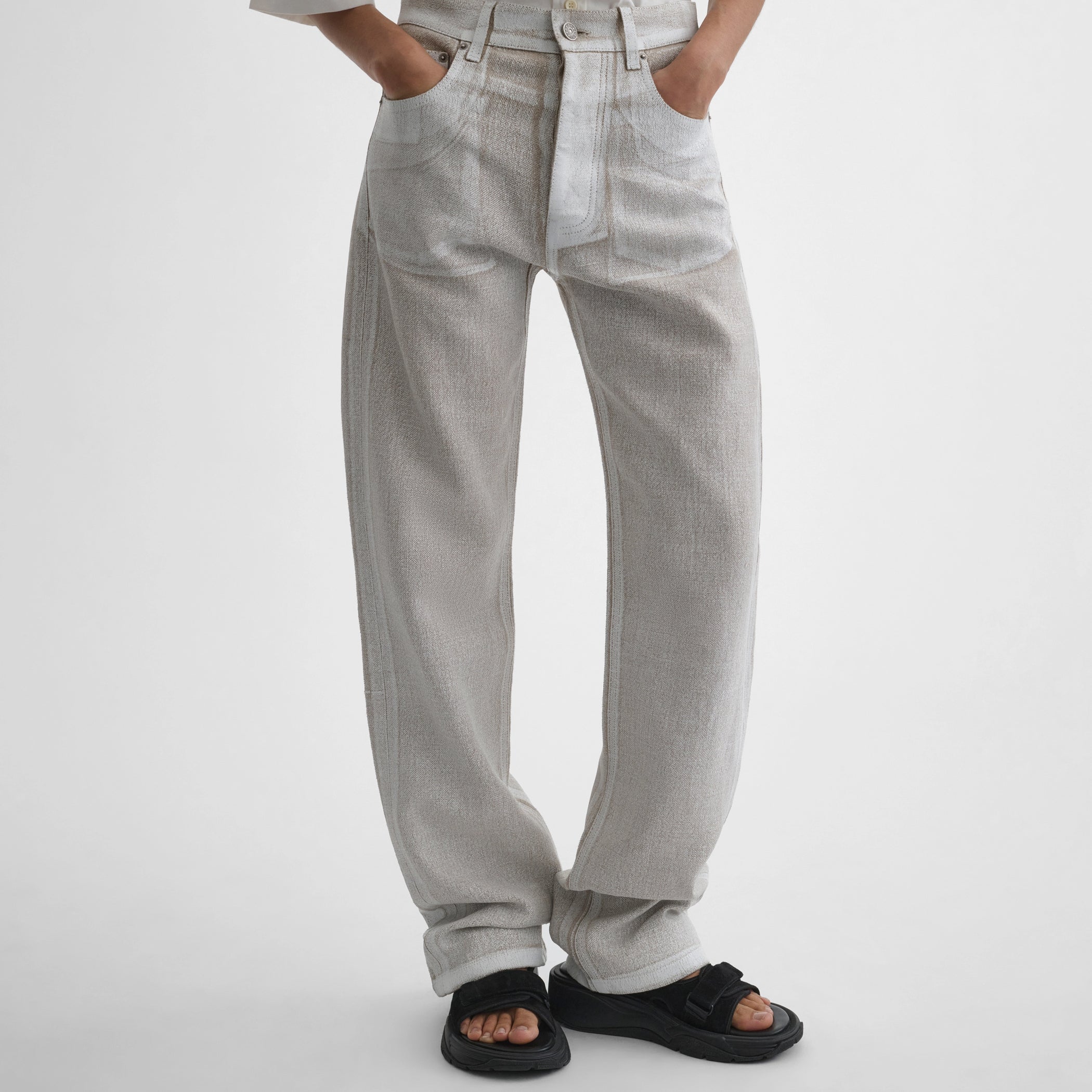 Front close up view of model wearing the classic jeans in hay