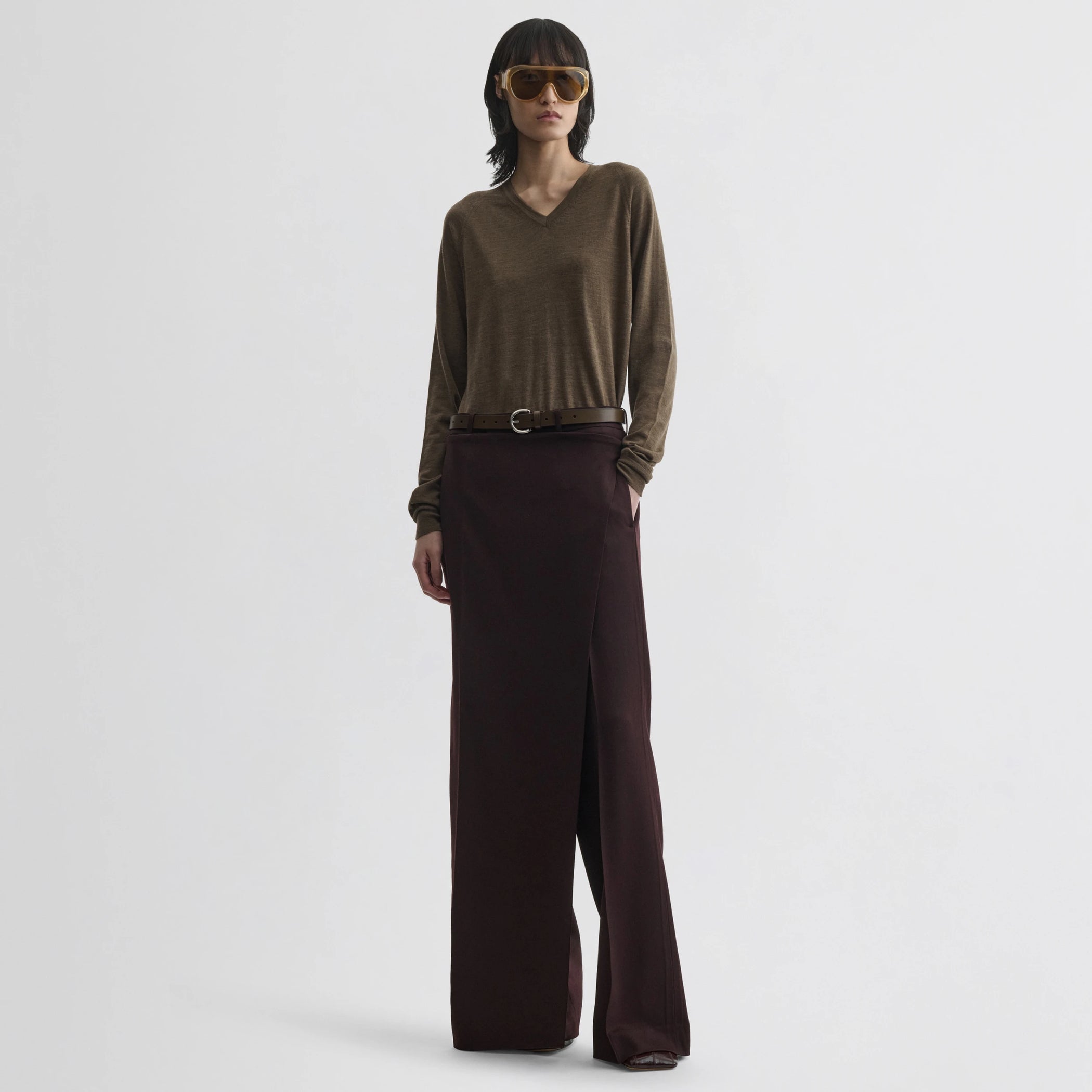 Front view of model wearing apron trousers in chocolate wool.