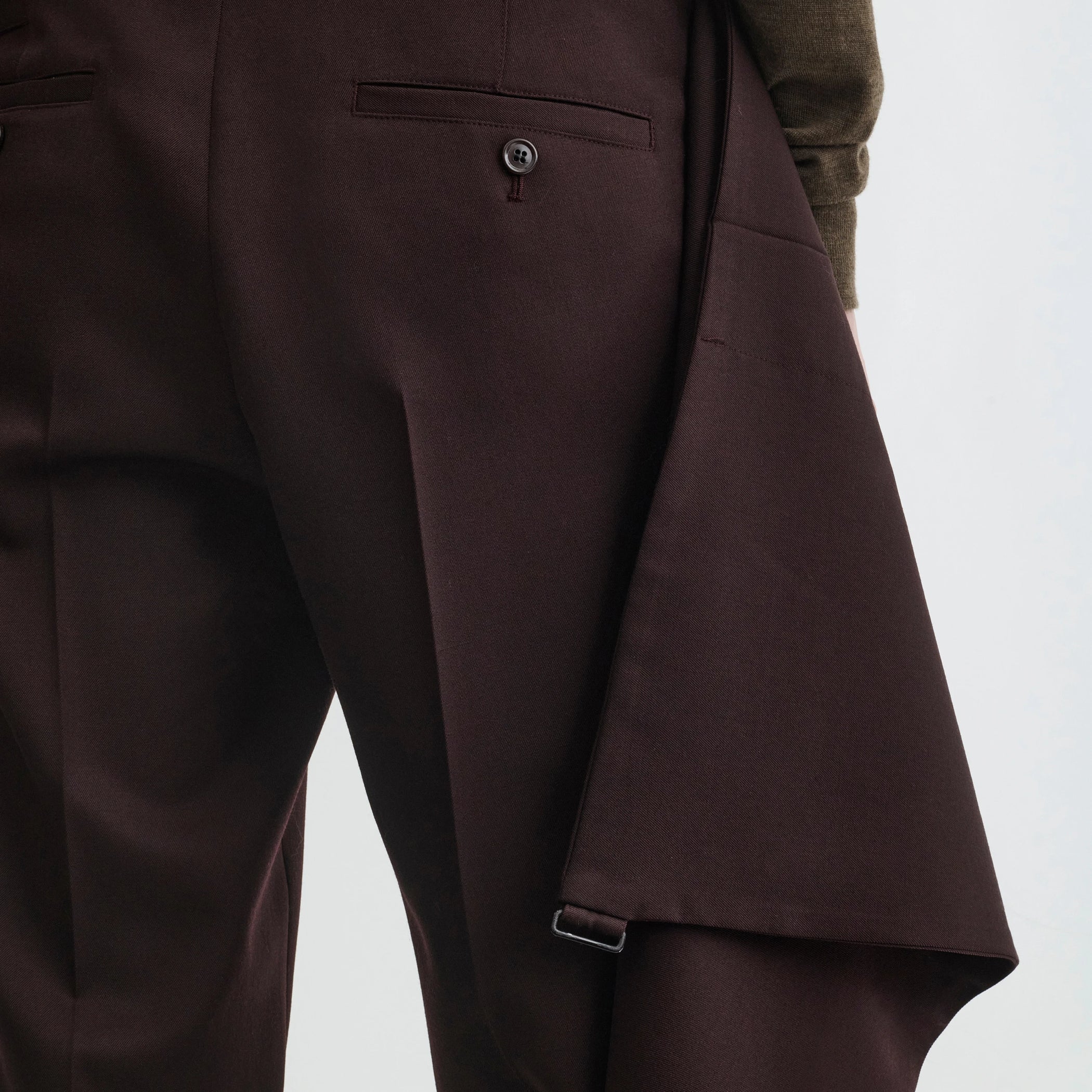 Close up detail view of apron trousers in chocolate wool.