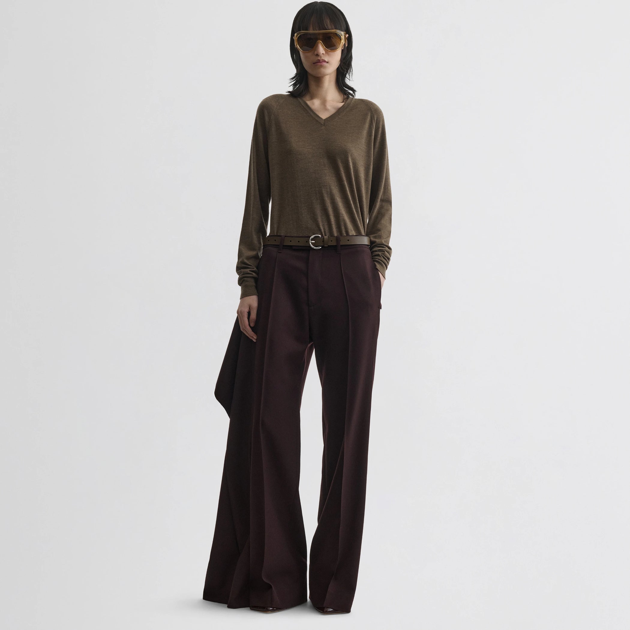 Front view of model wearing apron trousers in chocolate wool.