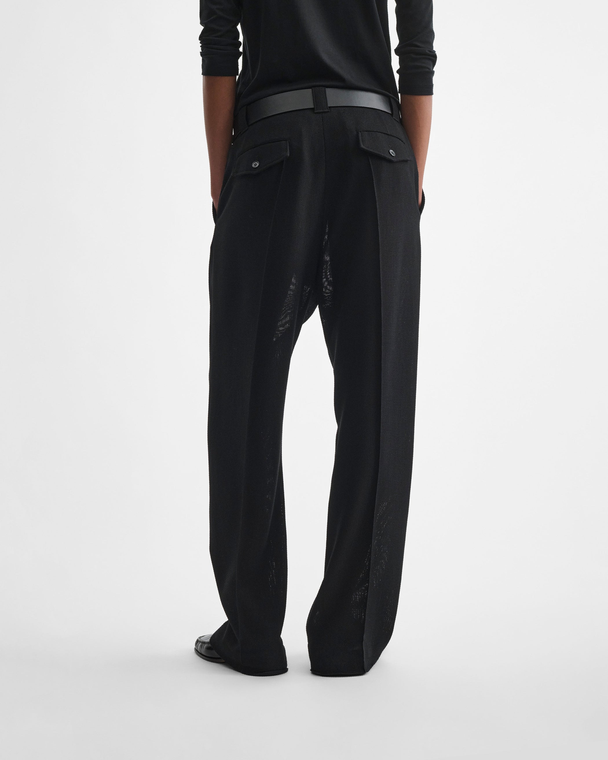 Back view of model wearing OVERSIZED TROUSERS in black viscose